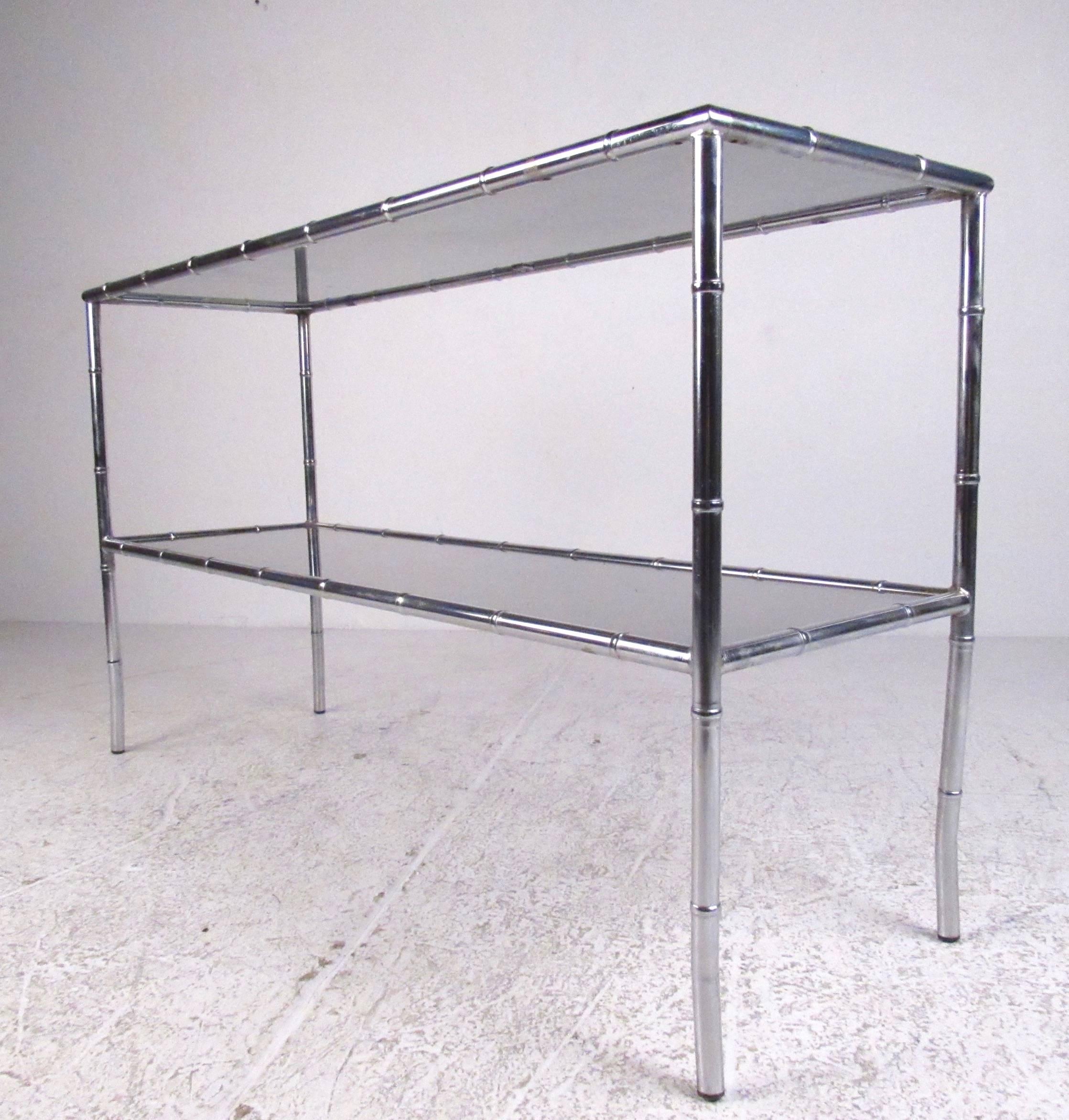 Stylish chrome and smoked glass console table, ideal for use behind a sofa, hallway, or office. Decorator style faux bamboo detail makes this a unique addition to any interior. Please confirm item location (NY or NJ).