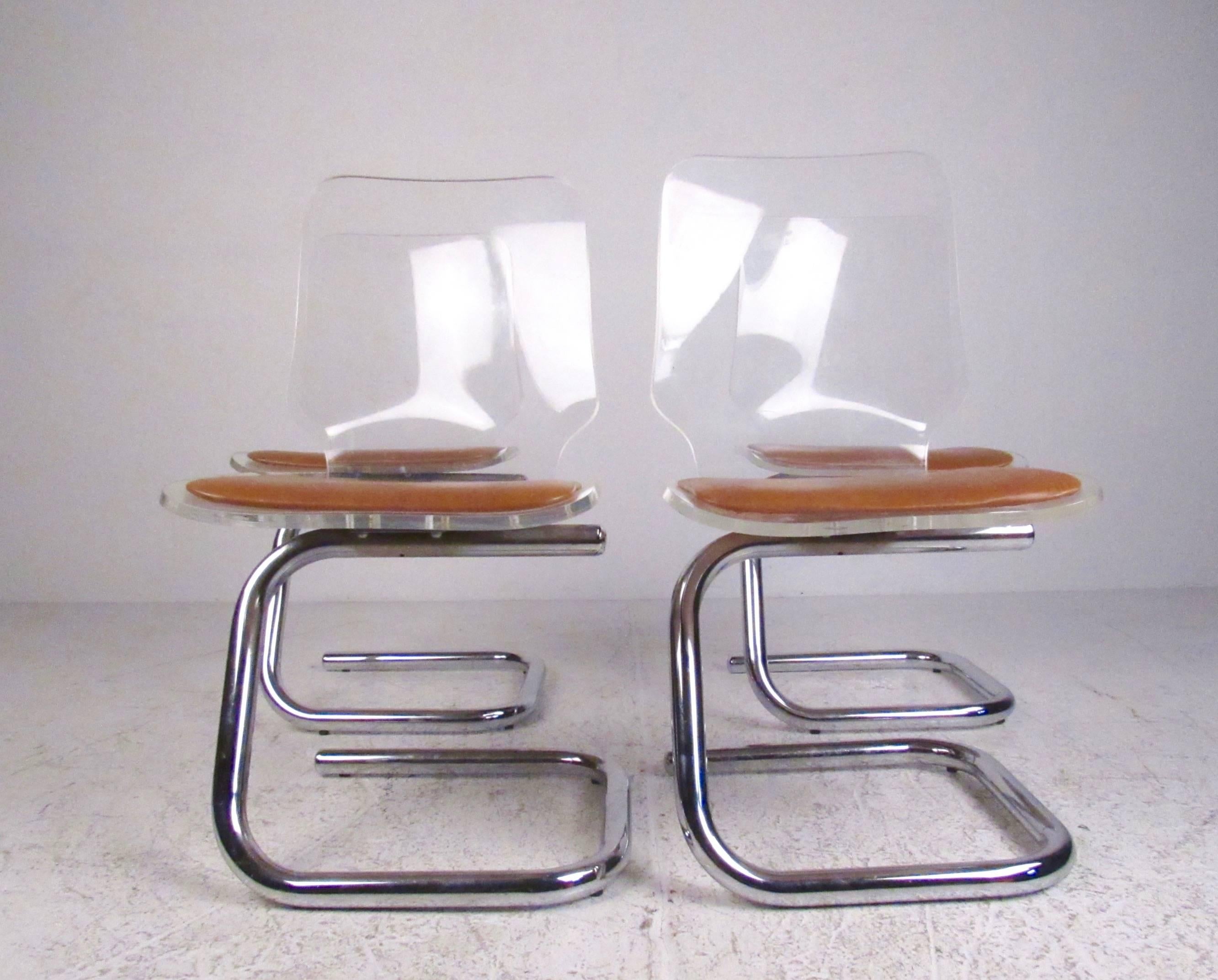 This set of four vintage modern Lucite dining chairs feature cantilever chrome bases, comfortable padded seats, and impressive Mid-Century style. Wonderful matching set of Luigi Bandini dining chairs perfect for kitchen, dining room, or conference