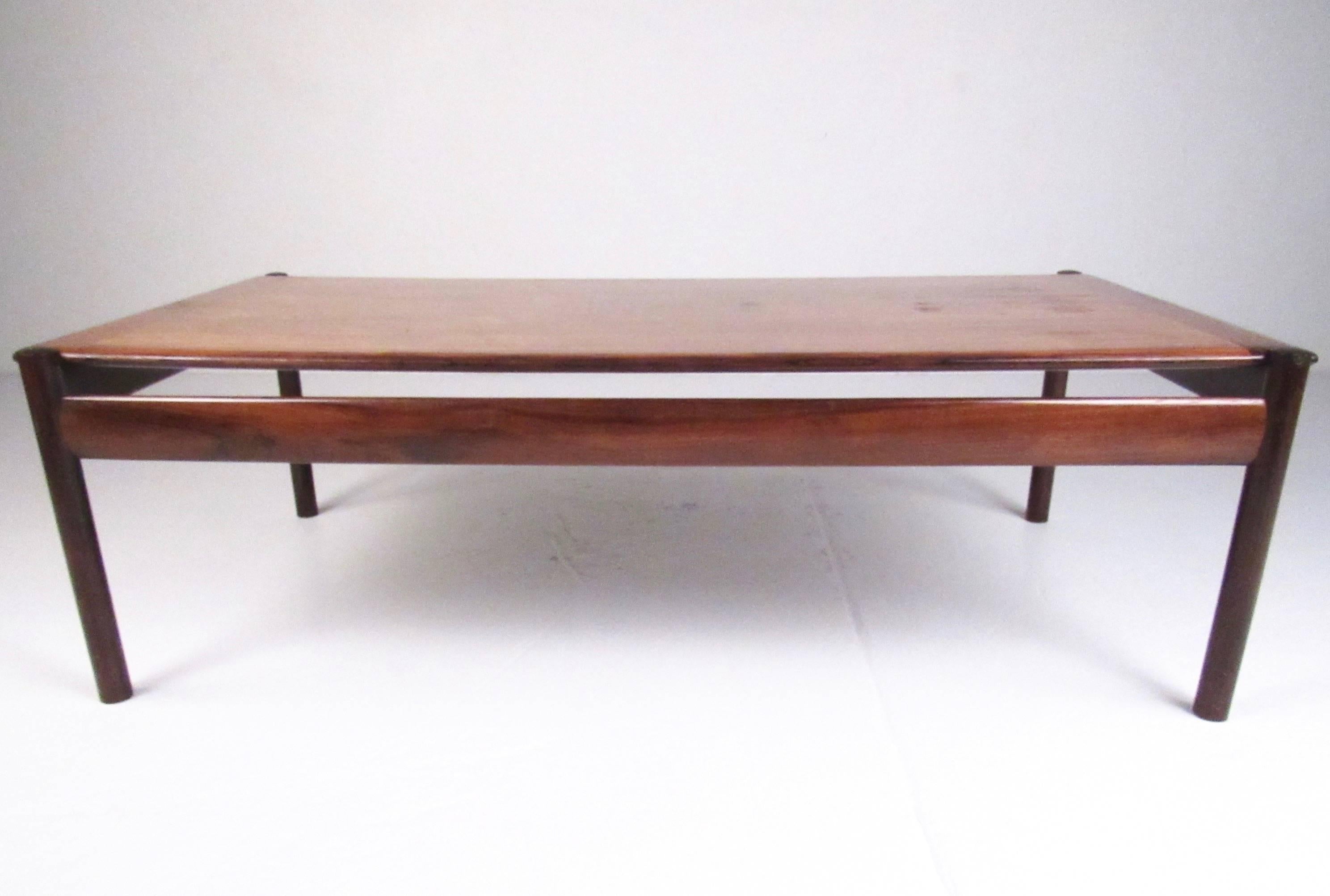 This stunning Mid-Century coffee table features high-quality design by Sven Ivar Dysthe for Dokka of Norway. Rich rosewood finish and carefully crafted design make this an impressive addition to any seating area. Please confirm item location (NY or