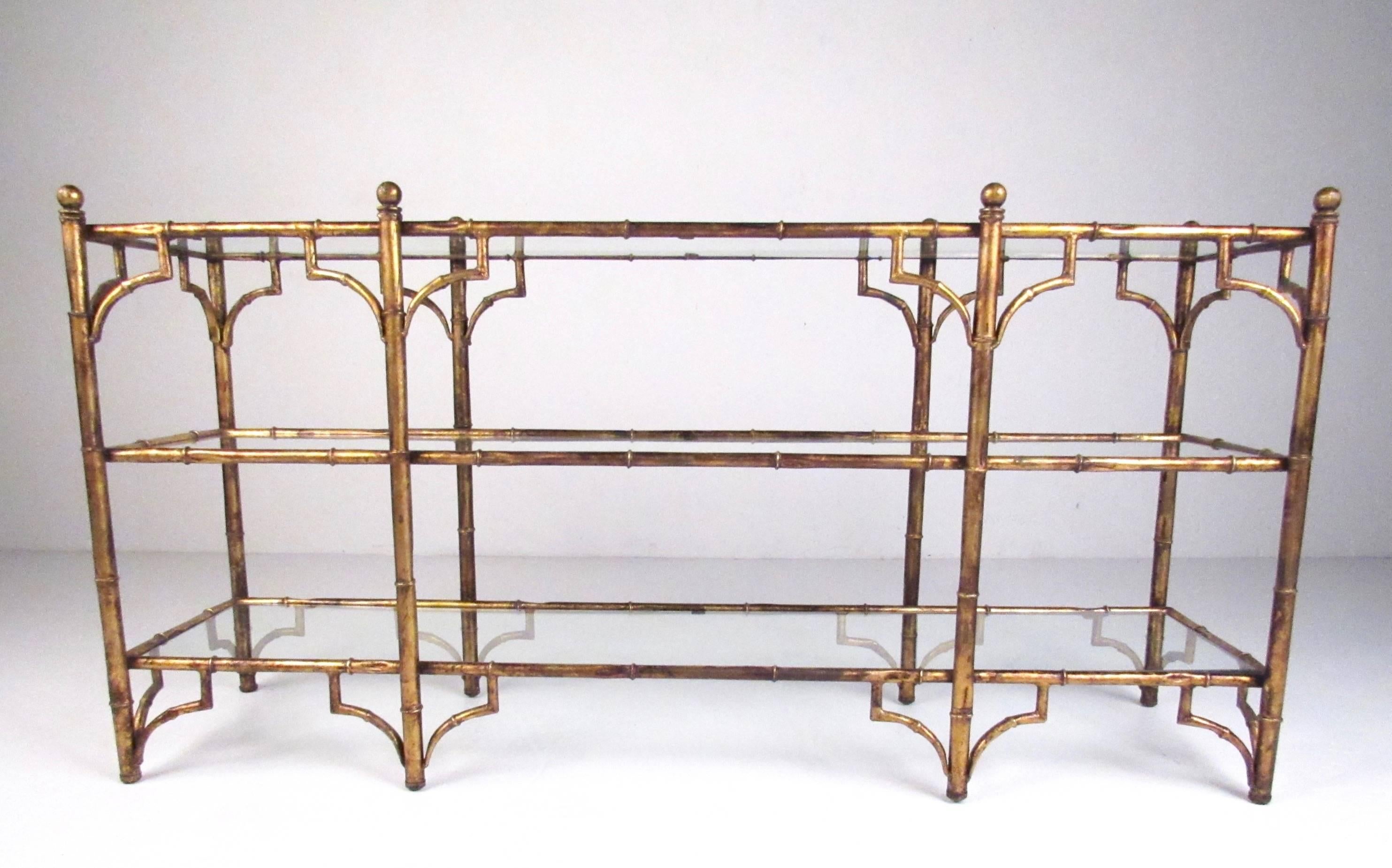 This unique decorator style console table features faux bamboo metal finish and three glass shelves for storage or display. Perfect piece for hall or entryway use, or for shop display. Please confirm item location (NY or NJ).