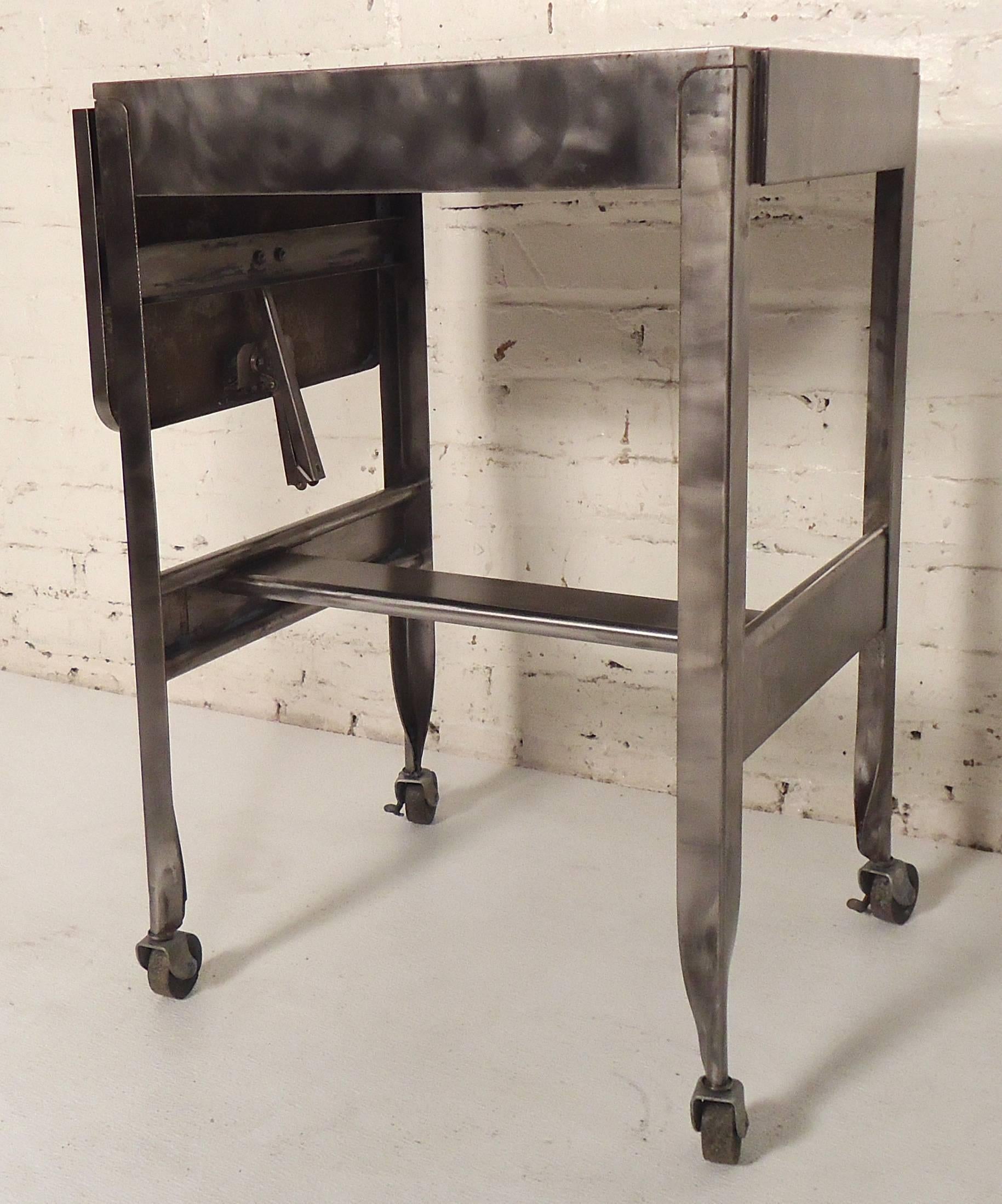 Small side table restored in a bare metal style finish. Features a drop leaf extension and locking wheels.
Opens to 27