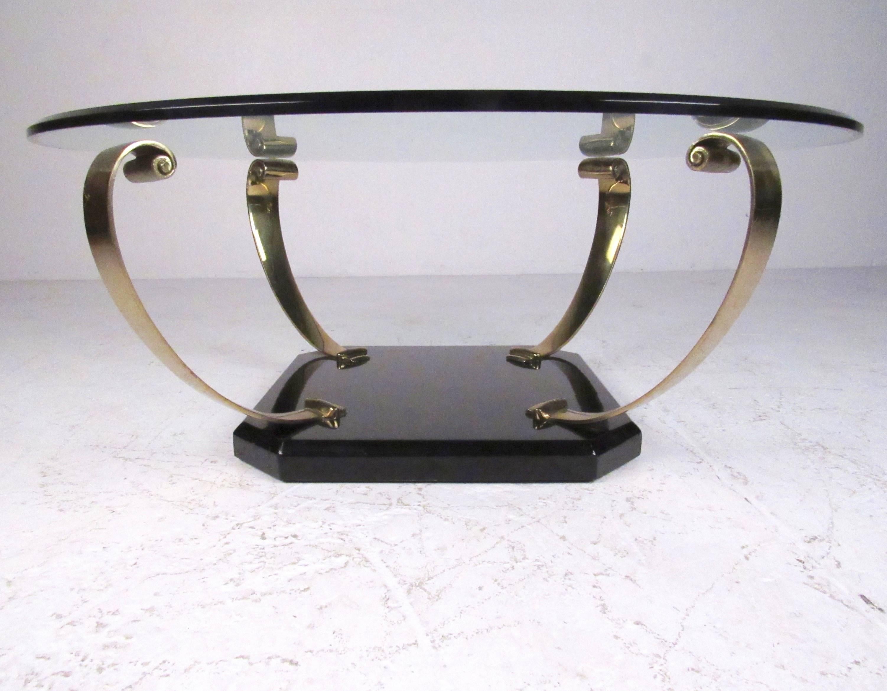 This stylish vintage coffee table features scrolled brass arms mounted on a black lacquer base with a bevelled glass top. Impressive Regency style makes a striking addition to home or business, please confirm item location (NY or NJ).