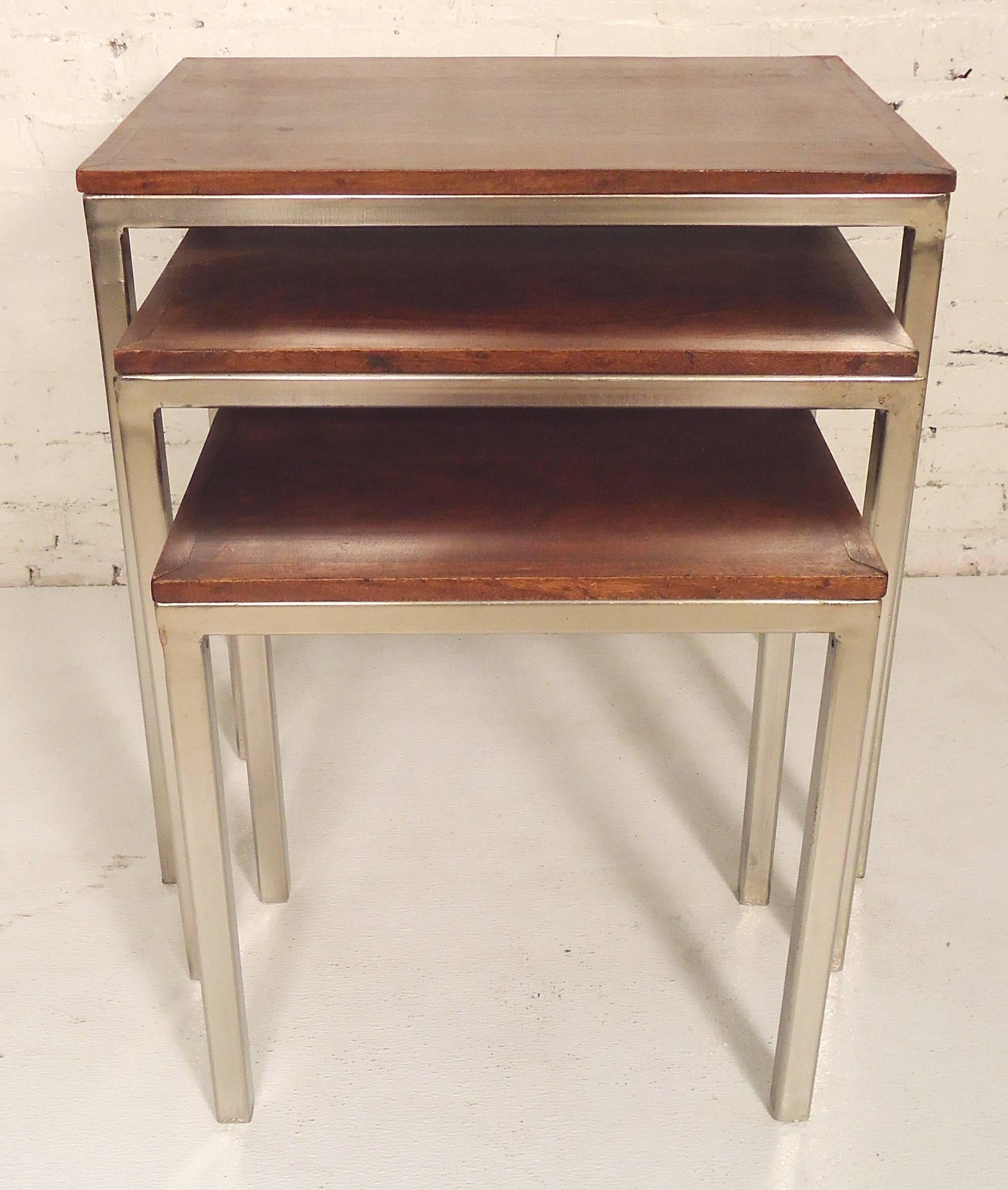 Three nesting side tables with polished chrome frame and wood tops. In the style of Florence Knoll's chrome tables.
Measure: Large 24 x 16 x 24.5
Medium 21 x 12.5 x 21.5
Small 17 x 10 x 18

(Please confirm item location, NY or NJ, with