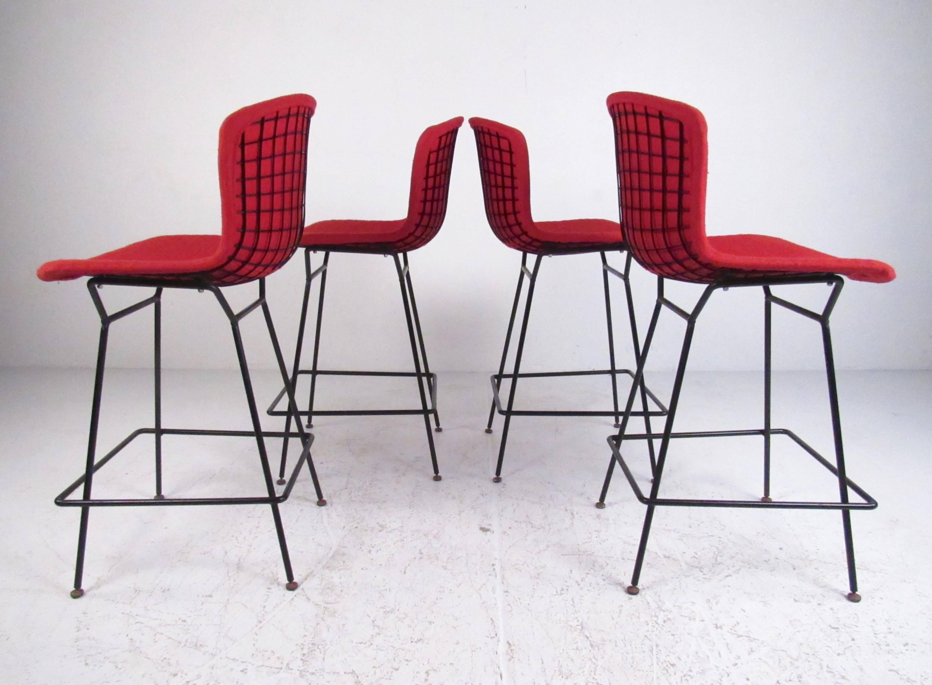 This comfortable set of four counter height barstools feature the shapely steel wire frames made popular by designer Harry Bertoia for Knoll Associates. The bonded black finish is wonderfully complimented by the vintage fabric seat covers. Please