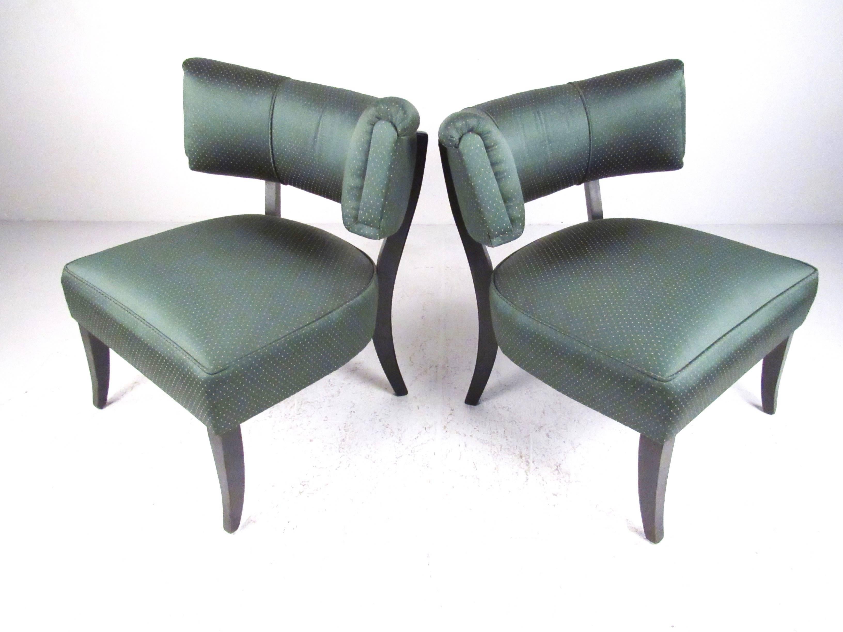 This comfortable pair of barrel back slipper chairs makes an elegant yet simple statement in home or office. Plush upholstery, shapely design, and curved hardwood legs add to the vintage Art Deco style of the matching pair. Please confirm item