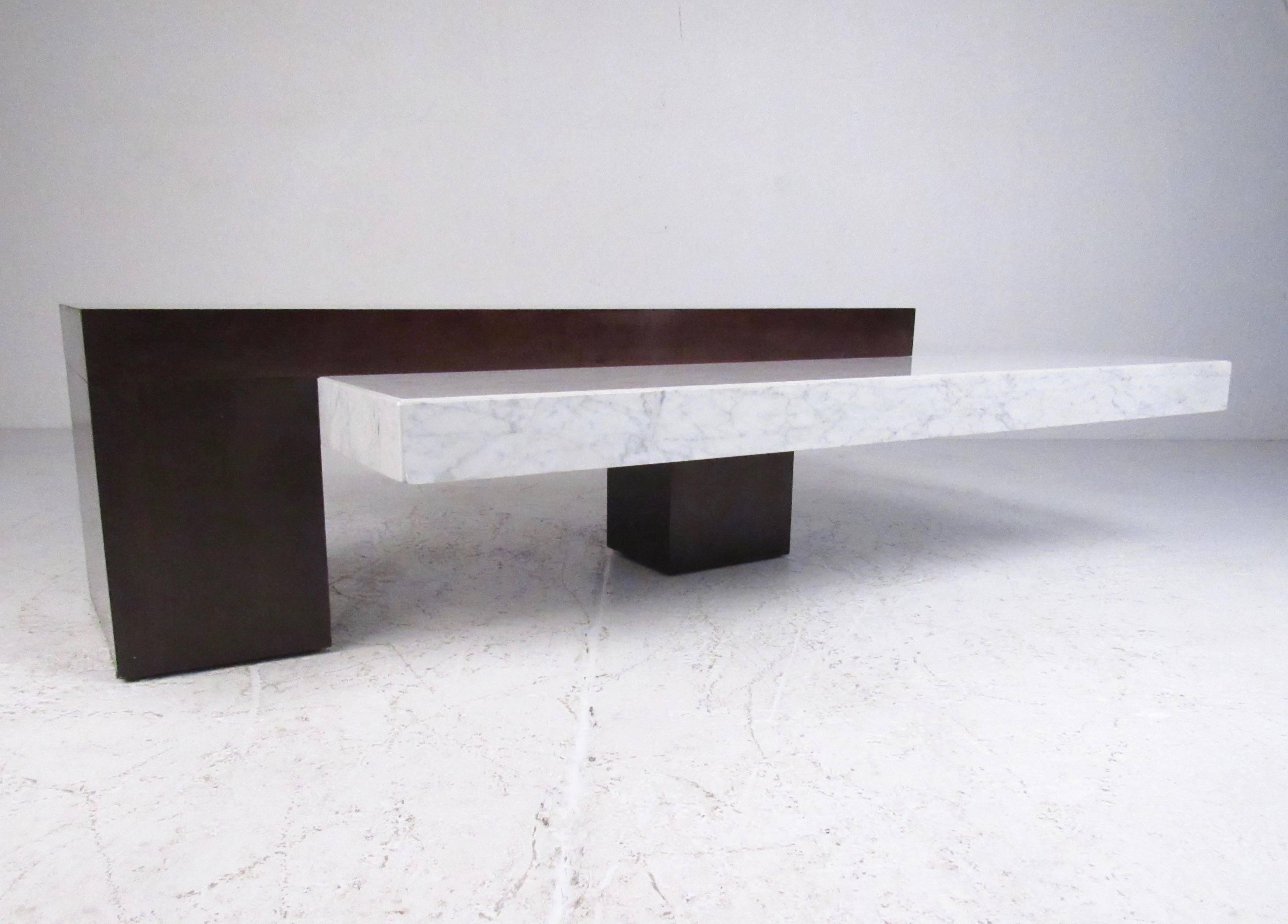 This gorgeous Italian marble coffee table features cantilever like design with a rich mahogany finish base with heavy marble top. Impressive cocktail table for any seating area makes a stylish modern addition to home or office. Please confirm item