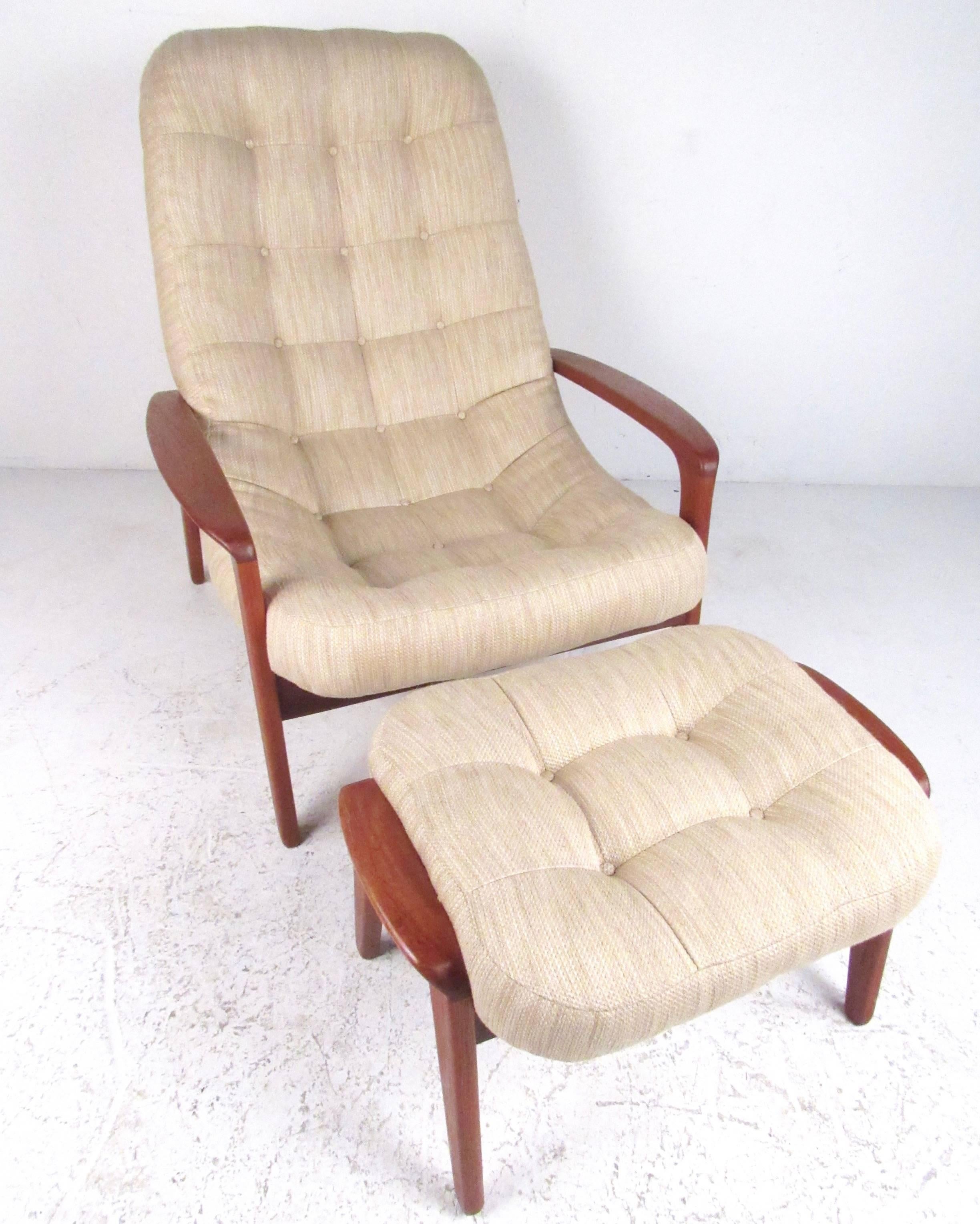 This unique vintage modern lounge chair features a sturdy teak frame with comfortable sloped back, sculpted teak arm rests, and matching upholstered ottoman. The stylish design of this vintage Canadian made set make a striking addition to home or