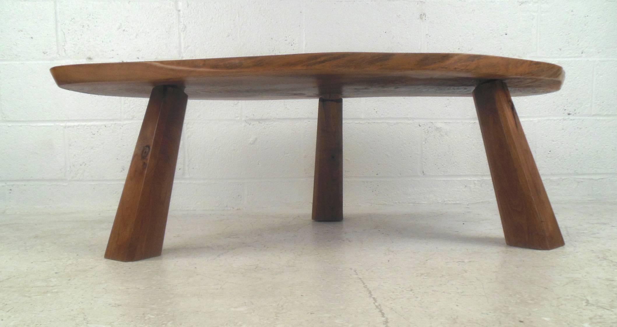 This beautiful vintage modern coffee table feature a unique tree slab top with elegant wood grain. Stylish design with thick wood legs that taper upward ensuring maximum sturdiness. This stunning live edge table offers a taste of nature within any