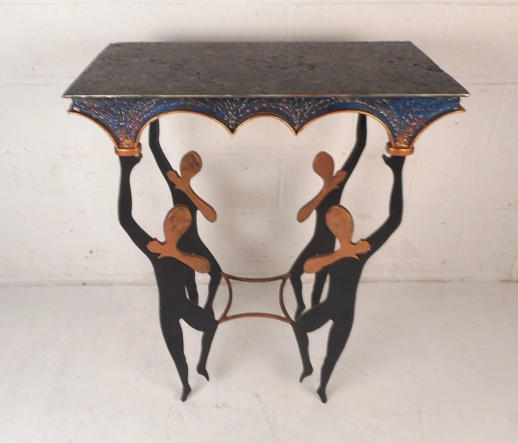 This stunning Mid-Century Modern table features an extremely heavy frame with unique ballerina designs functioning as the legs. This exquisite piece has various colors within the metal and sculpted detail throughout. This is a versatile piece that