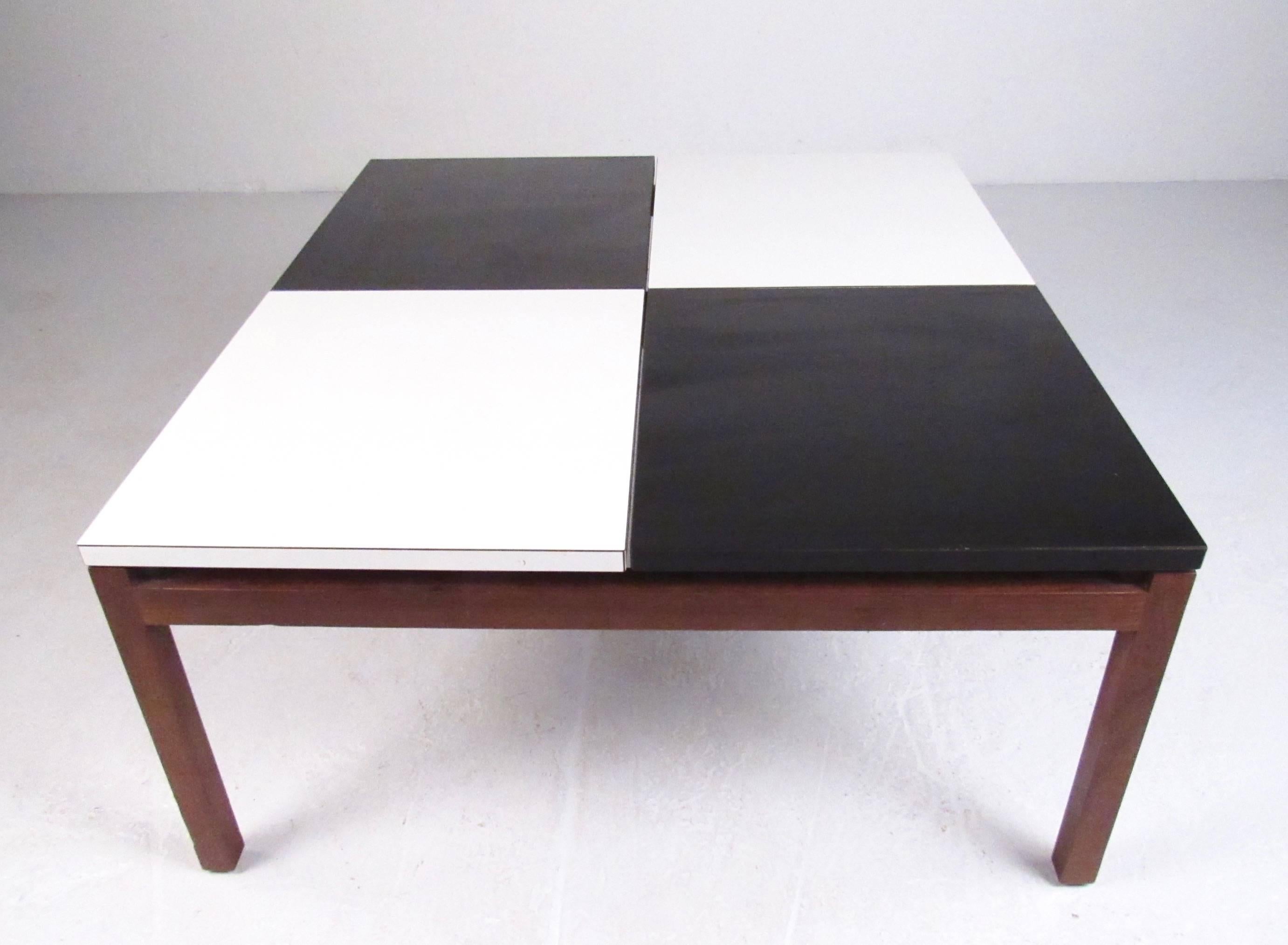 This stylish 1960s cocktail table was designed by Lewis Butler for Knoll Associates Inc. and showcased iconic black and white checkerboard design with hardwood base. Unique Mid-Century Modern style makes this eye-catching coffee table the perfect