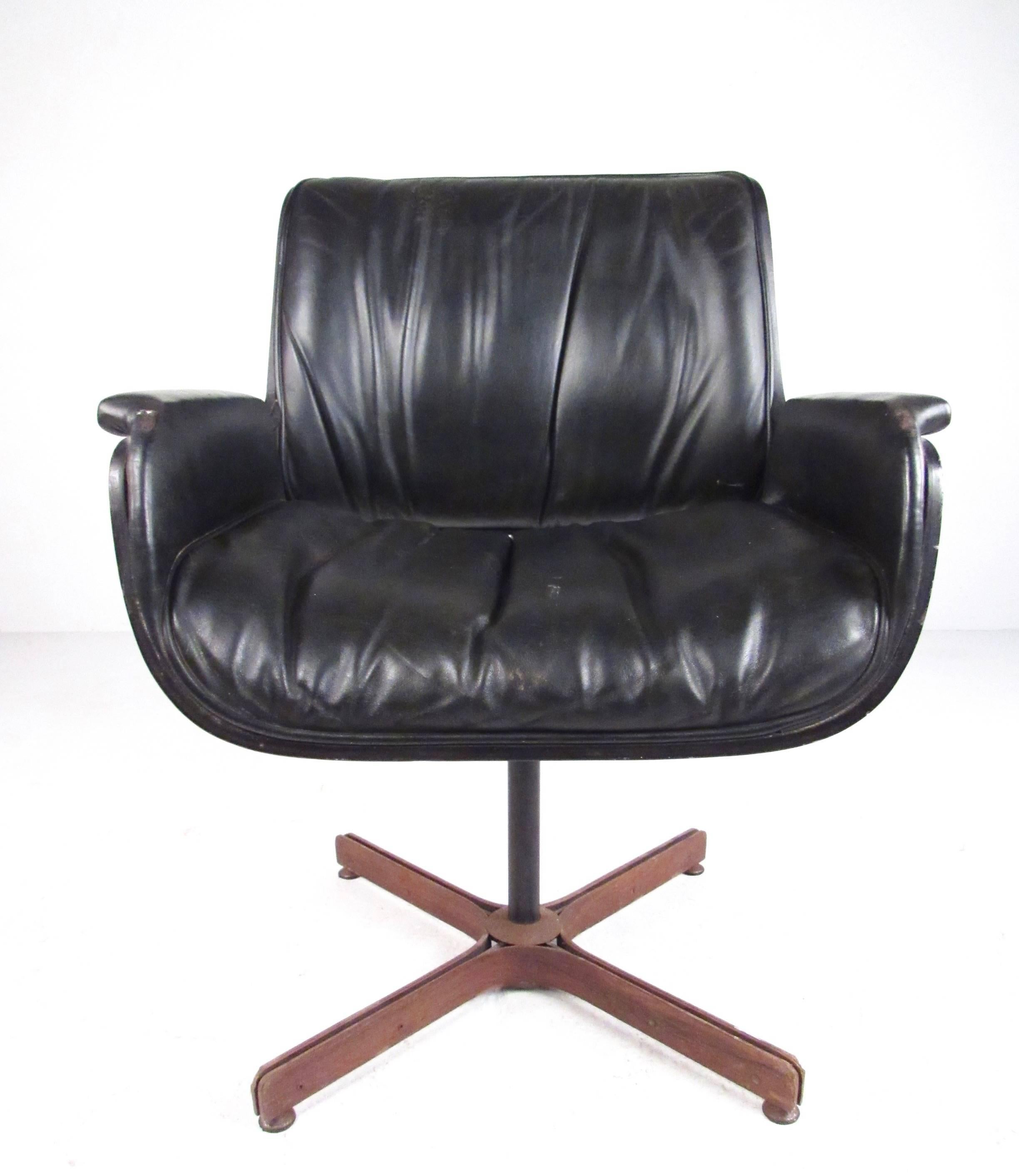 This unique Plycraft style leather armchair features bentwood shell design, plush vintage leather upholstery, and metal swivel base. Stylish modern design makes a Classic midcentury addition to any home or office interior. Please confirm item