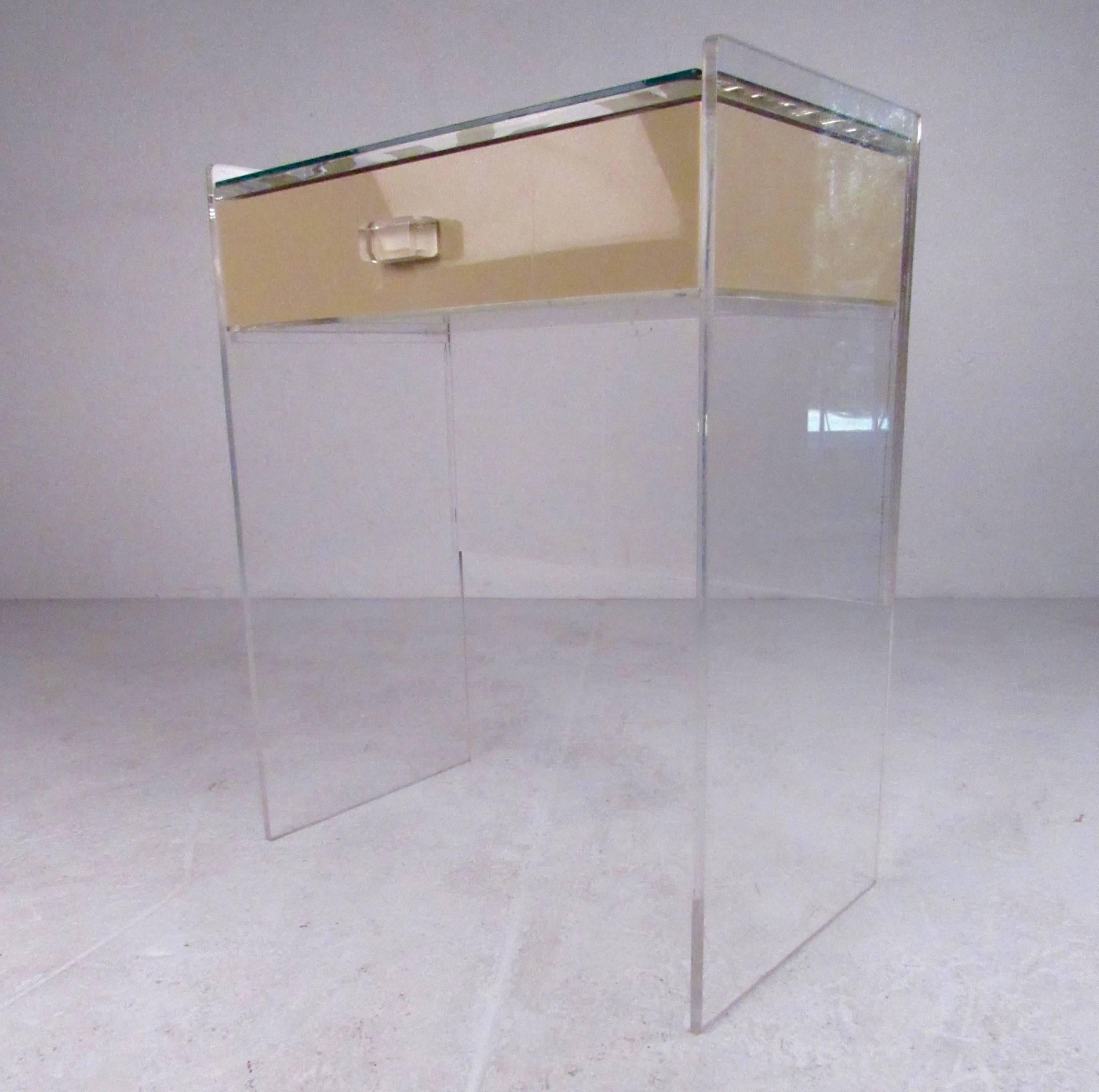 This vintage modern vanity table features stylish acrylic and mirror construction with, and Charles Hollis Jones style design. Spacious top drawer makes this unique console table the perfect makeup table or vanity piece for home or business, while