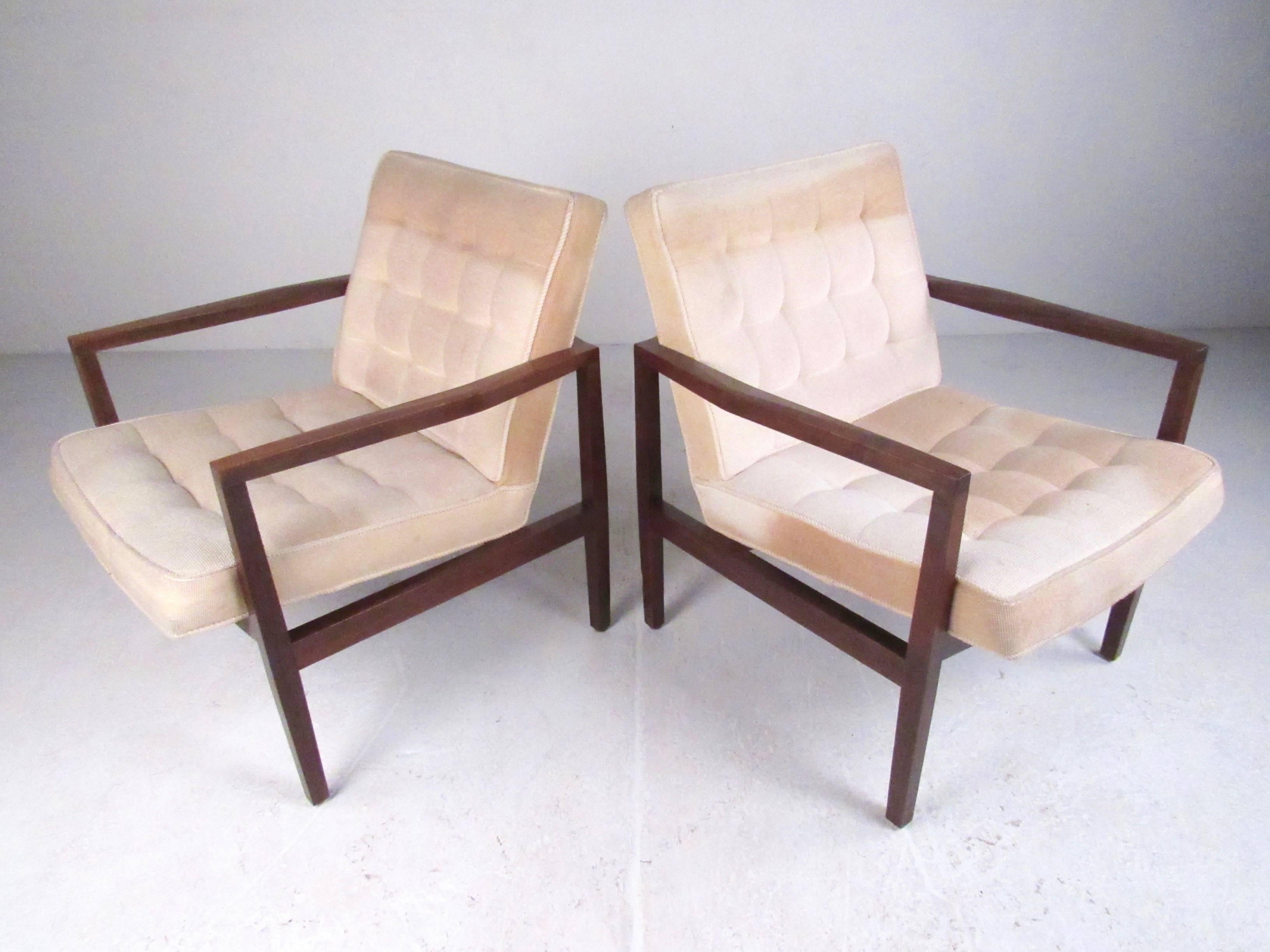 This stylish pair of vintage modern club chairs feature cubist style solid walnut frames with tufted vintage upholstery and comfortable proportions. Perfect pair of matching lounge chairs for home or business seating. Please confirm item location