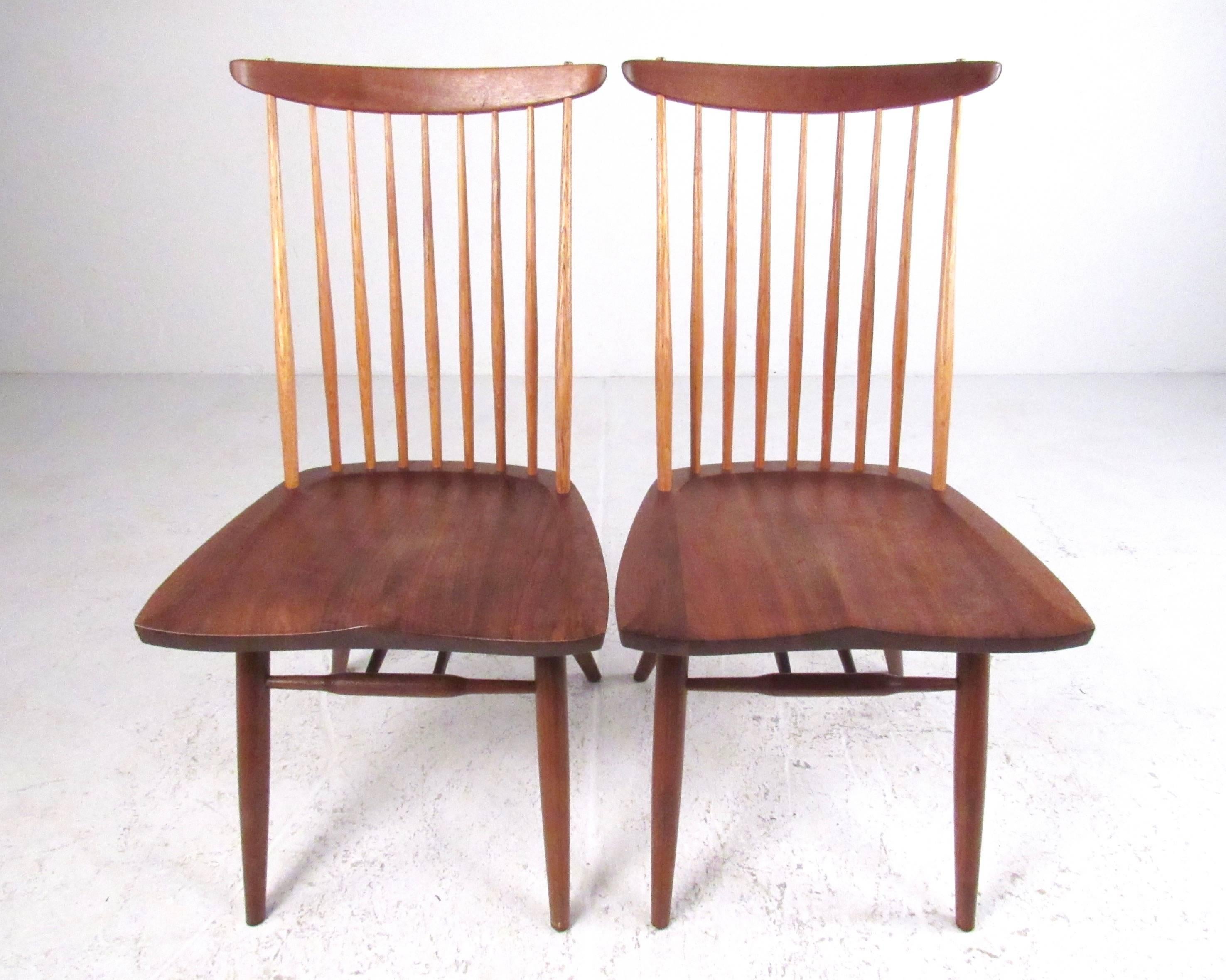 This matched pair of carefully constructed spindle back side chairs feature the sculptural details of the 