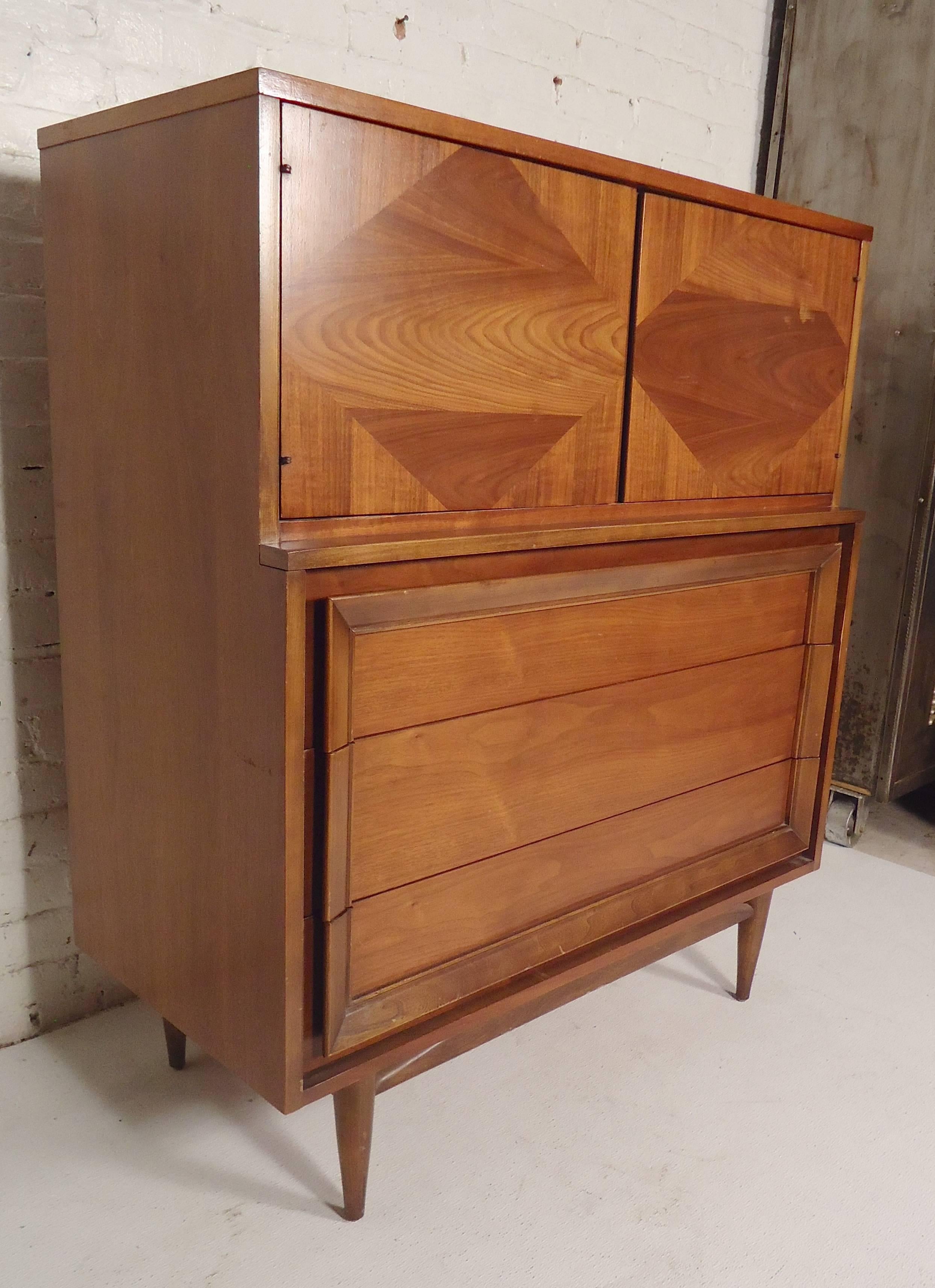 Tall dresser with top cabinet by Basic-Witz. Lovely walnut grain with diamond pattern, sculpted trim handles and tapered legs.

(Please confirm item location, NY or NJ, with dealer).
 