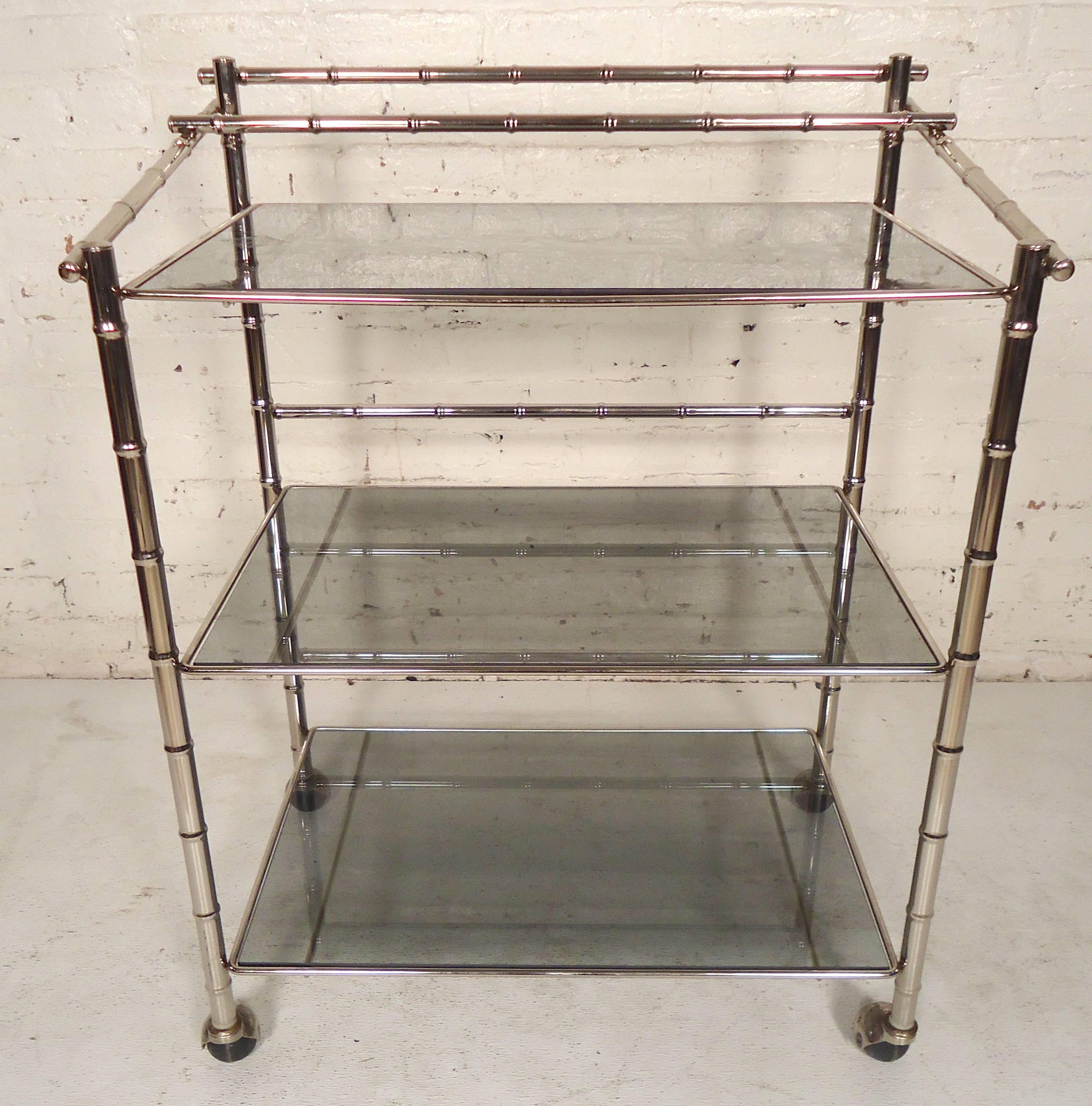 Bamboo style polished chrome cart with smoked glass shelves. Rolling casters, three total shelves.

(Please confirm item location, NY or NJ, with dealer).
 