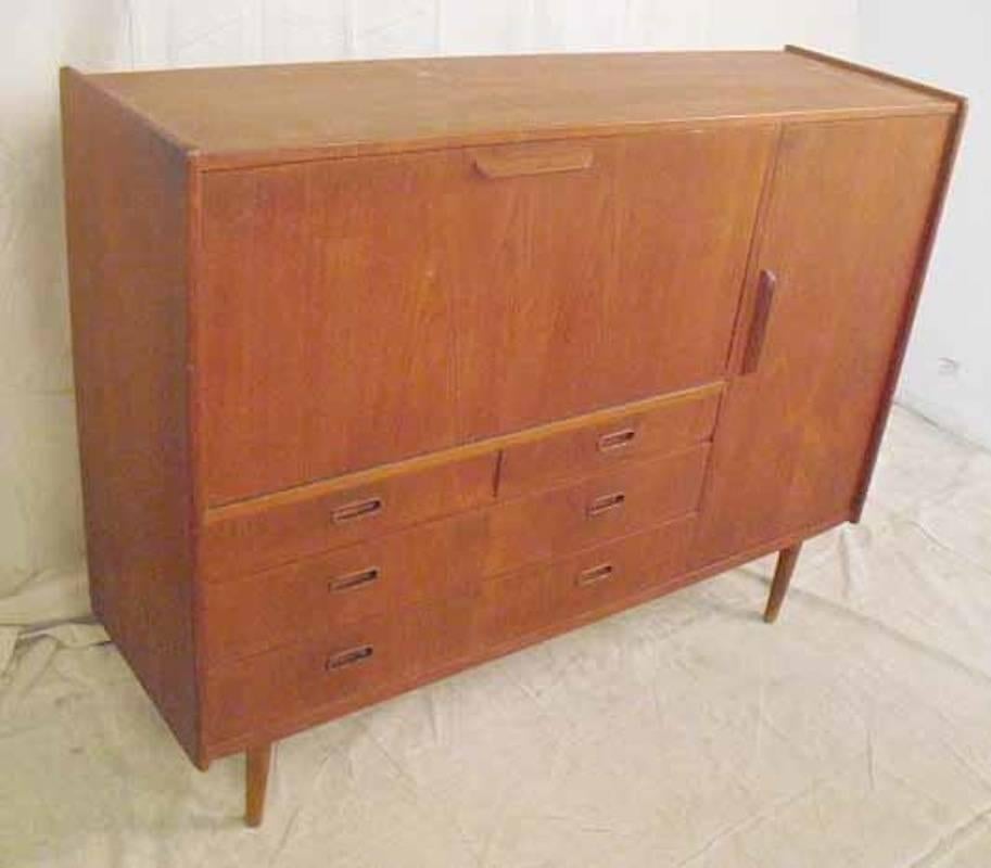 Tall mid-century modern cabinet with drop front cabinet/desk, drawer and cabinet storage. Nicely sculpted handles and tapered legs.

(Please confirm item location - NY or NJ - with dealer)
