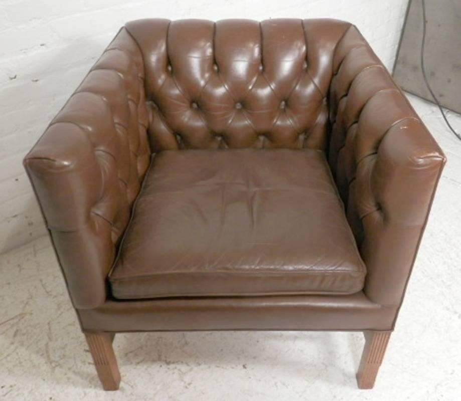Unusual shape arm chair with tufted inside back and sides. Sharp square lines, wood legs and brass nail trim.

(Please confirm item location - NY or NJ - with dealer)
