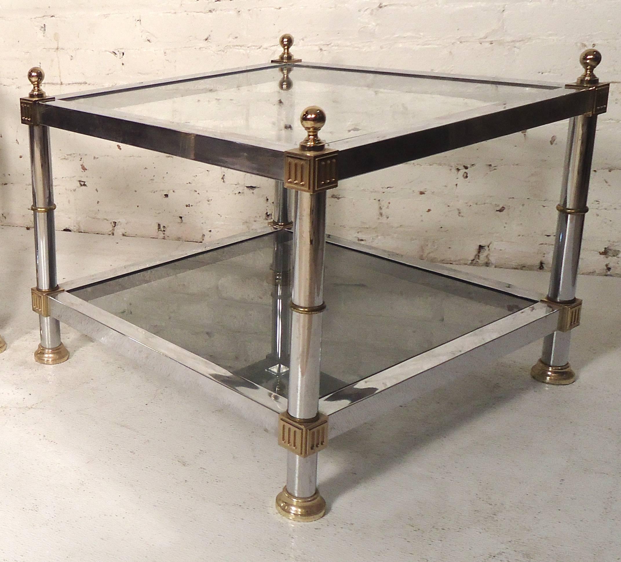 Two-tier side tables in polished chrome with brass accents. 

(Please confirm item location - NY or NJ - with dealer).
  