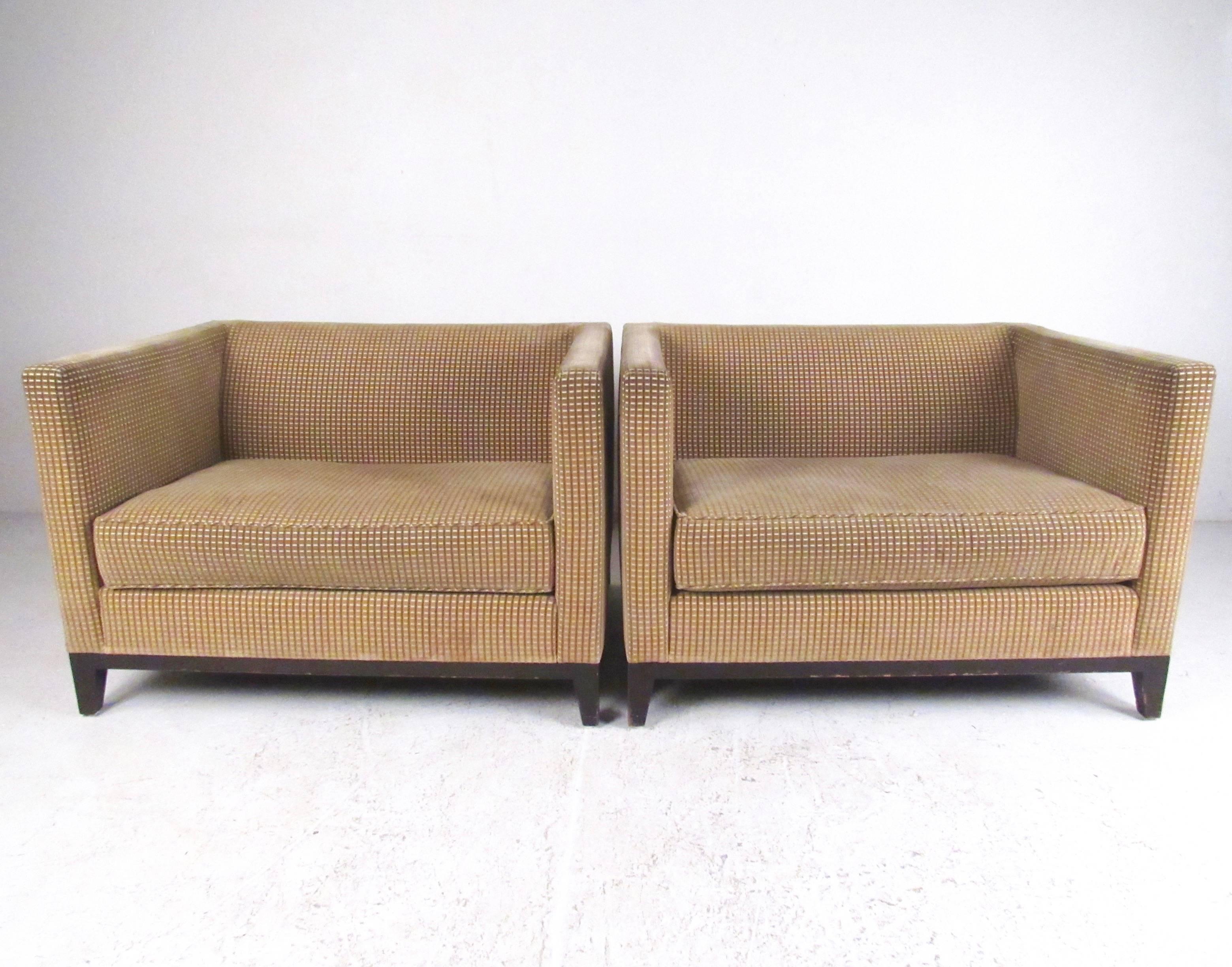 This stylish pair of oversized club chairs by Christian Liaigre for Holly Hunt makes a striking addition to home or business seating area. The clean modern design of this matched pair provides a unique seating set in any interior. Please confirm