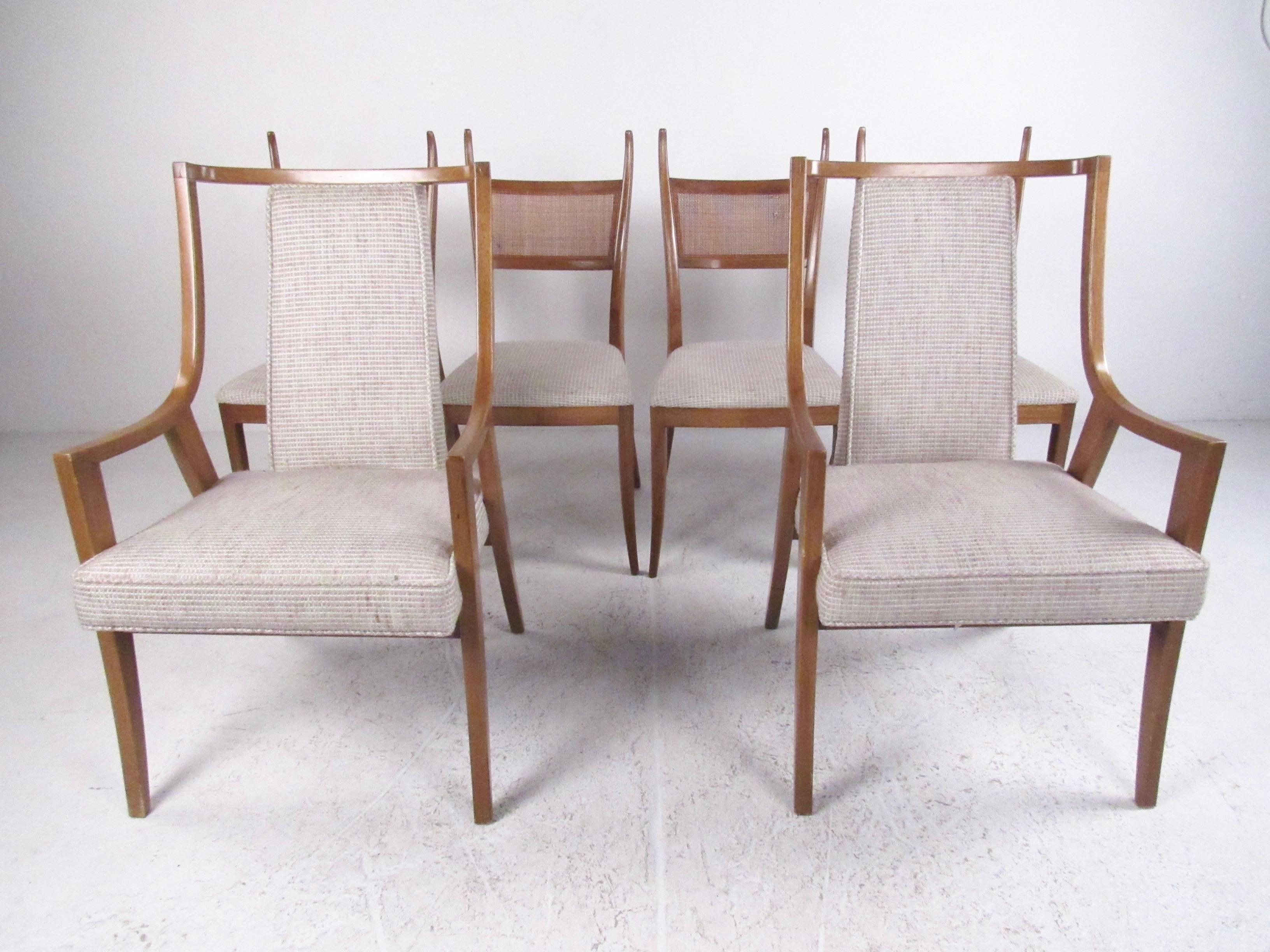 This stylish set of midcentury dining chairs features the unique sculptural design of Harvey Probber, making a comfortable yet stylish addition to any dining room setting. Four matched side chairs are paired with two sleek mahogany armchairs. The