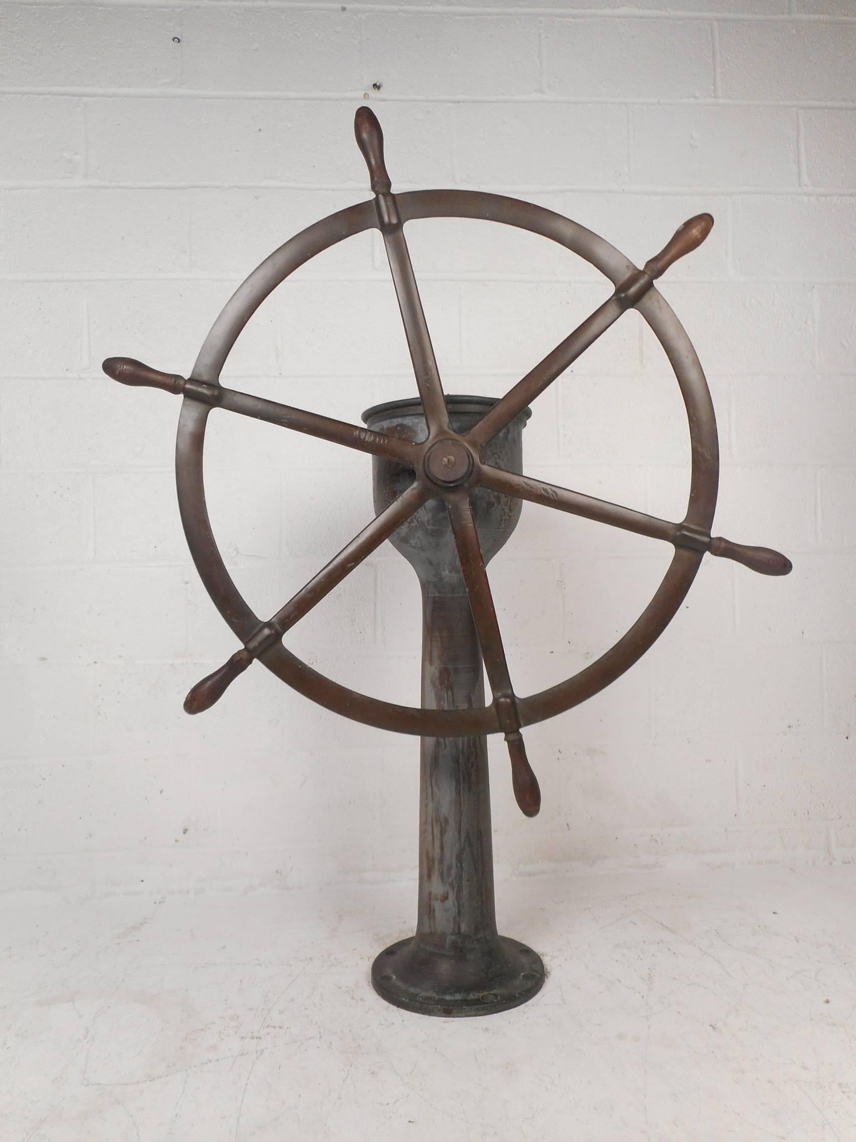 This stunning vintage steering station has a solid brass wheel with wooden handles and a bronze base. True quality construction labelled, 