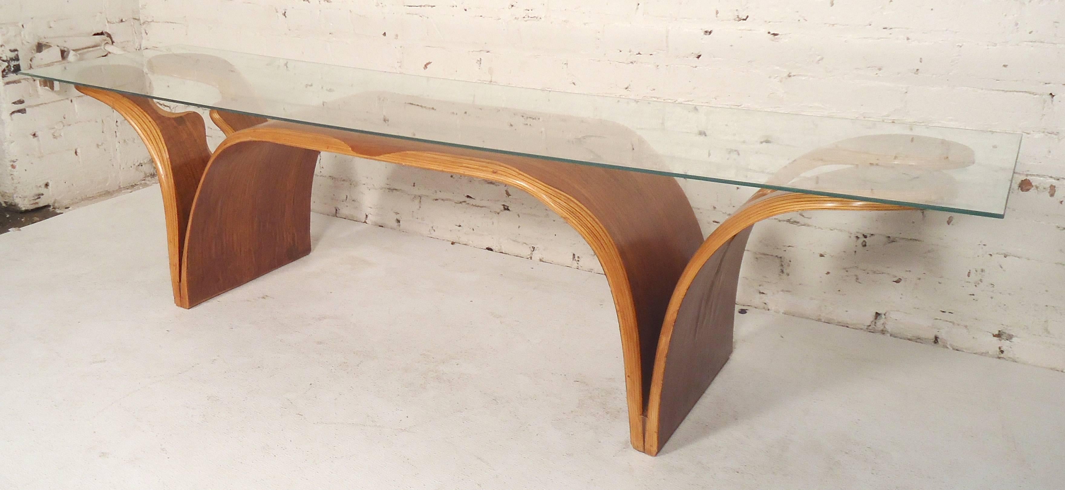 Very unusual coffee table base with thin glass top. Unique sculpted shape and two tone wood color.

(Please confirm item location - NY or NJ - with dealer).
 