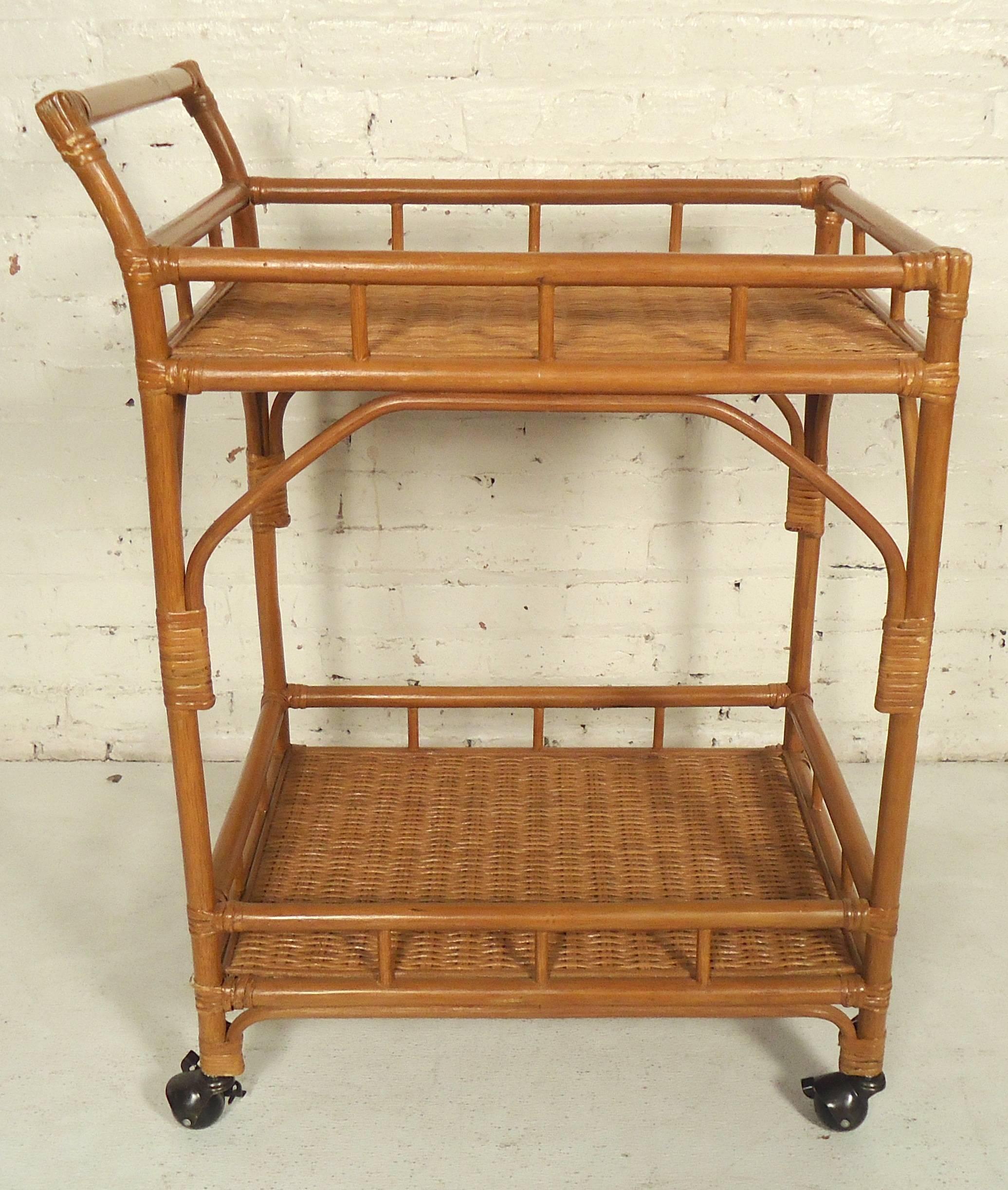 Rolling cart with two shelf levels and nice wicker accents throughout. Great as a serving or bar cart.

(Please confirm item location - NY or NJ - with dealer).
  