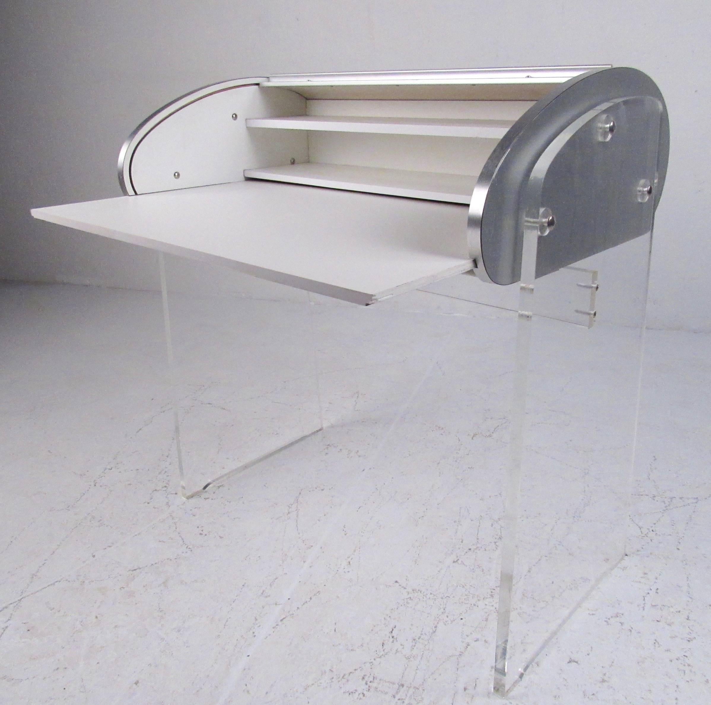 This stylish modern roll top desk features a Lucite base and aluminum finish tambour desk. Pull out writing space allows for plenty of workspace. Please confirm item location (NY or NJ).

Measure: Writing surface pulls out to 31.5 W x 18 D.