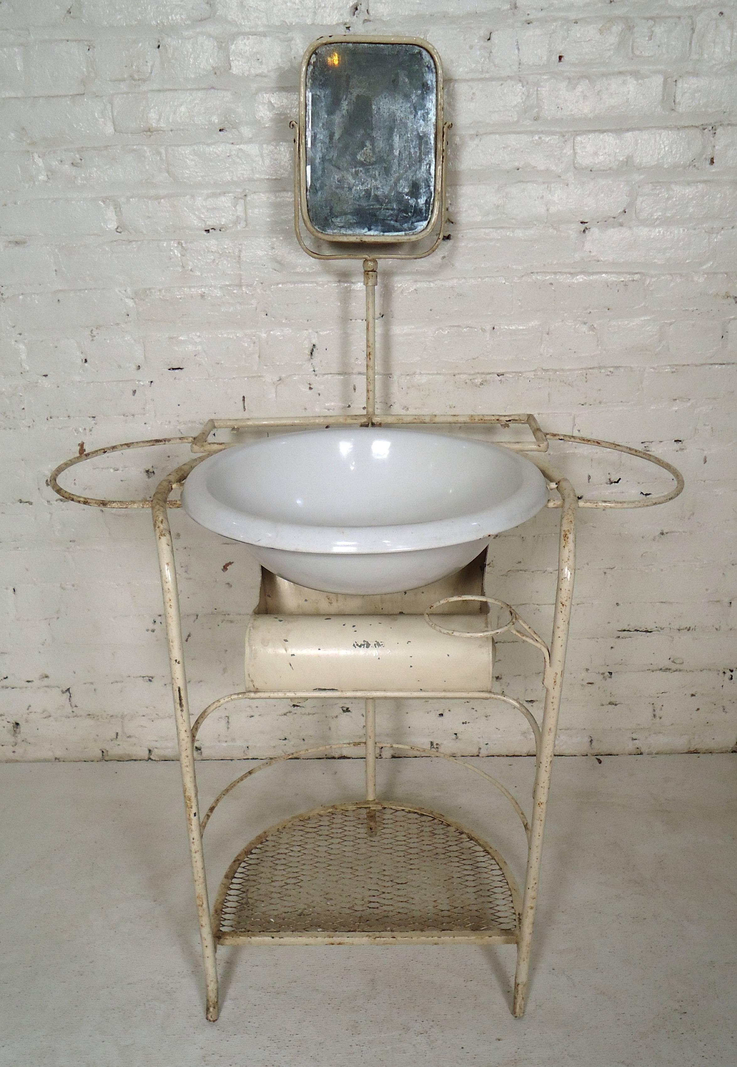 Unique vintage Industrial metal wash stand features wash bowl, small vintage mirror, bottom tier and cup holder.

Please confirm item location (NY or NJ).
 