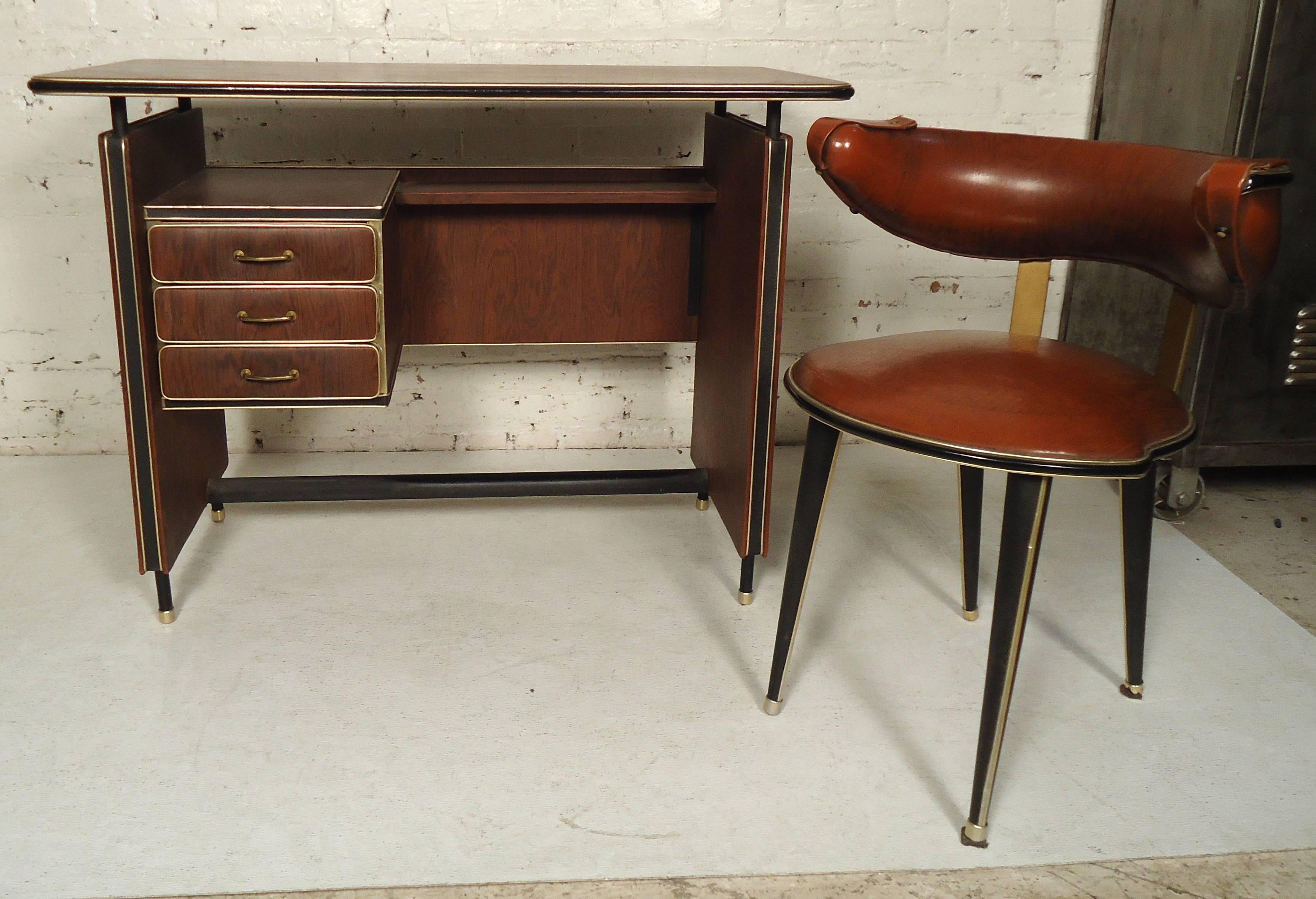 Very unusual Mid-Century Modern vinyl wrapped desk with wood grain. Chair features a round back, cushioned seating on sturdy legs.

Please confirm item location (NY or NJ).