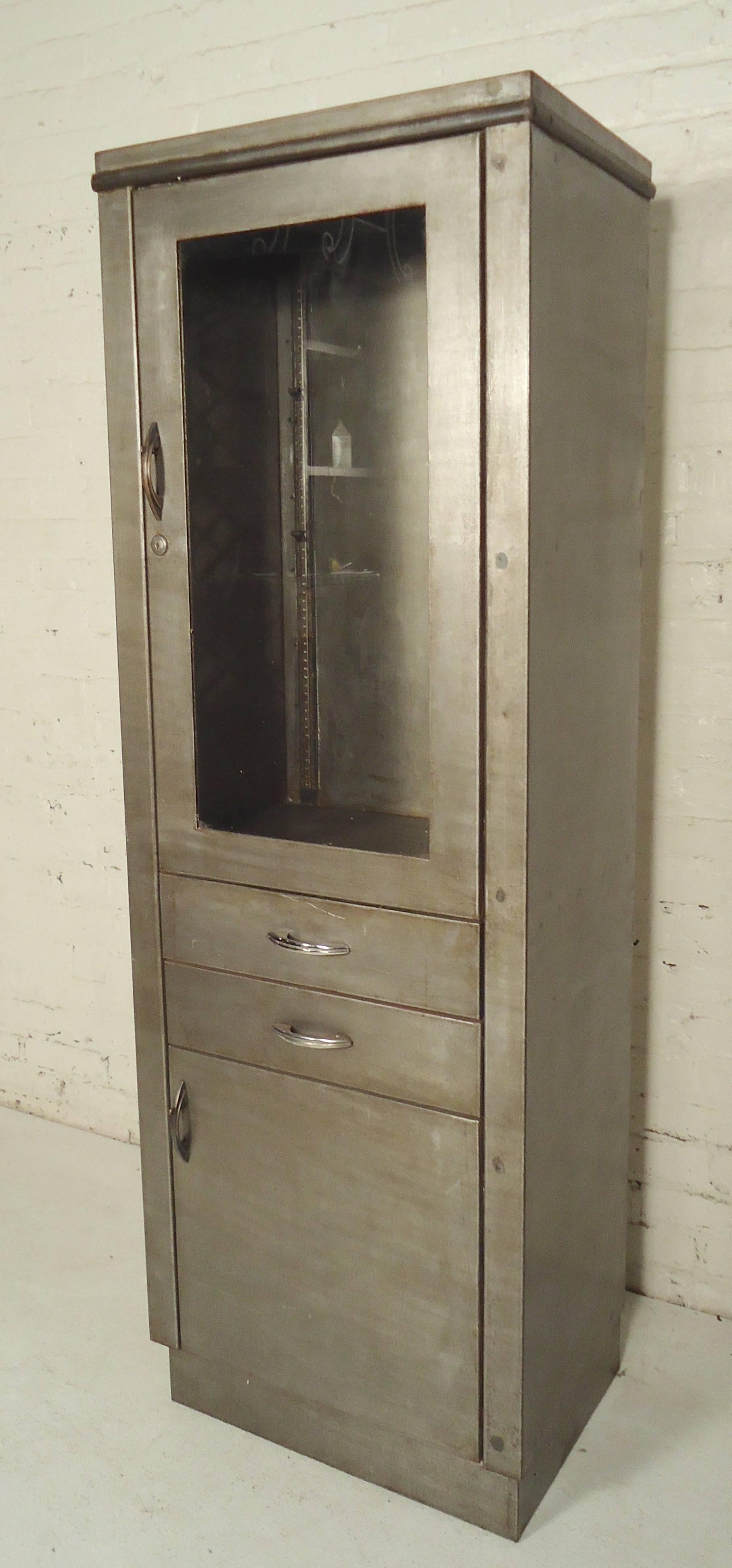 Doctors cabinet with glass front and bottom storage. Piece has been refinished in a bare metal style.

(Please confirm item location - NY or NJ - with dealer)
   