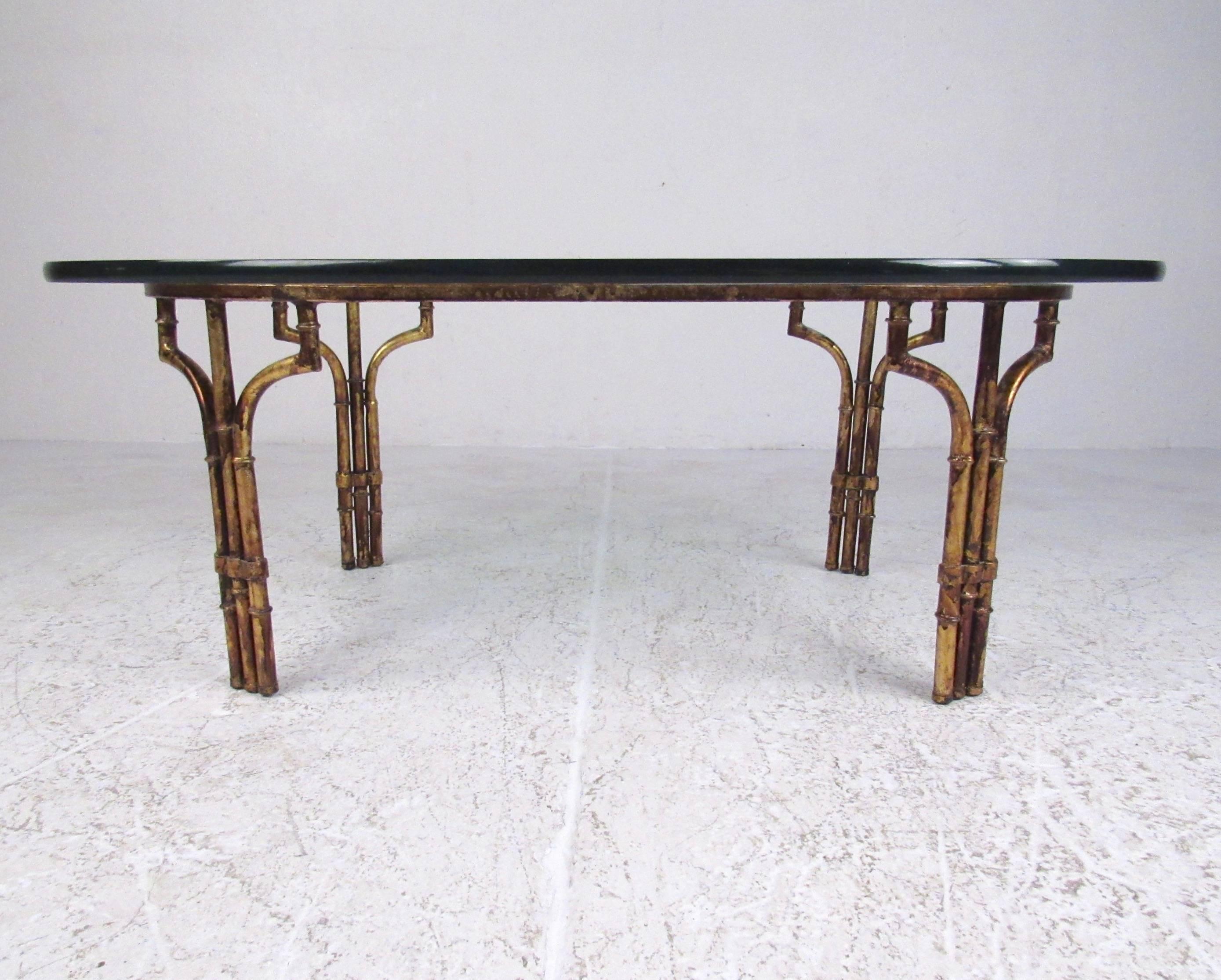 This stylish faux bamboo coffee table features a stylish gold finish base with great detail and a thick glass top. Nice size for home or office seating area, please confirm item location (NY or NJ). 