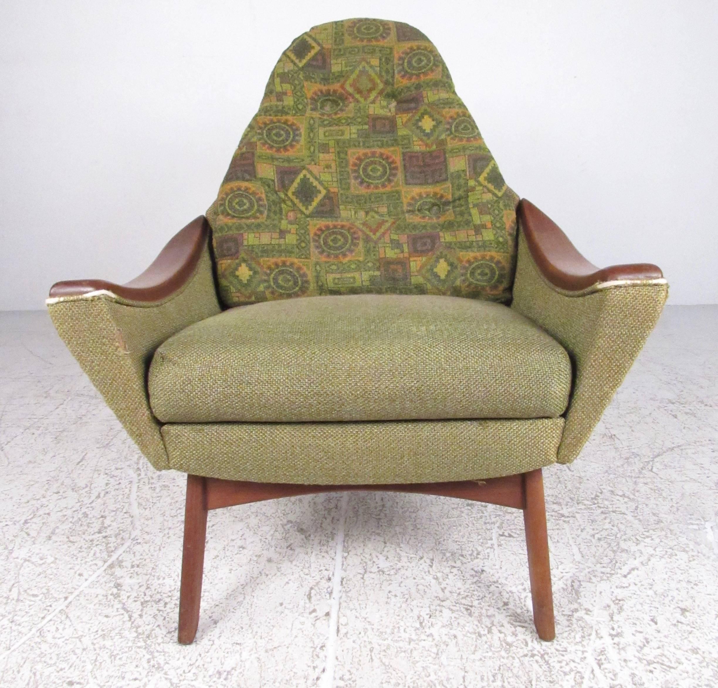 This unique high back lounge chair features vintage two tone fabric, unique sculpted walnut armrests, and comfortable proportions. Perfect vintage arm chair for living room or den. Please confirm item location (NY or NJ). 