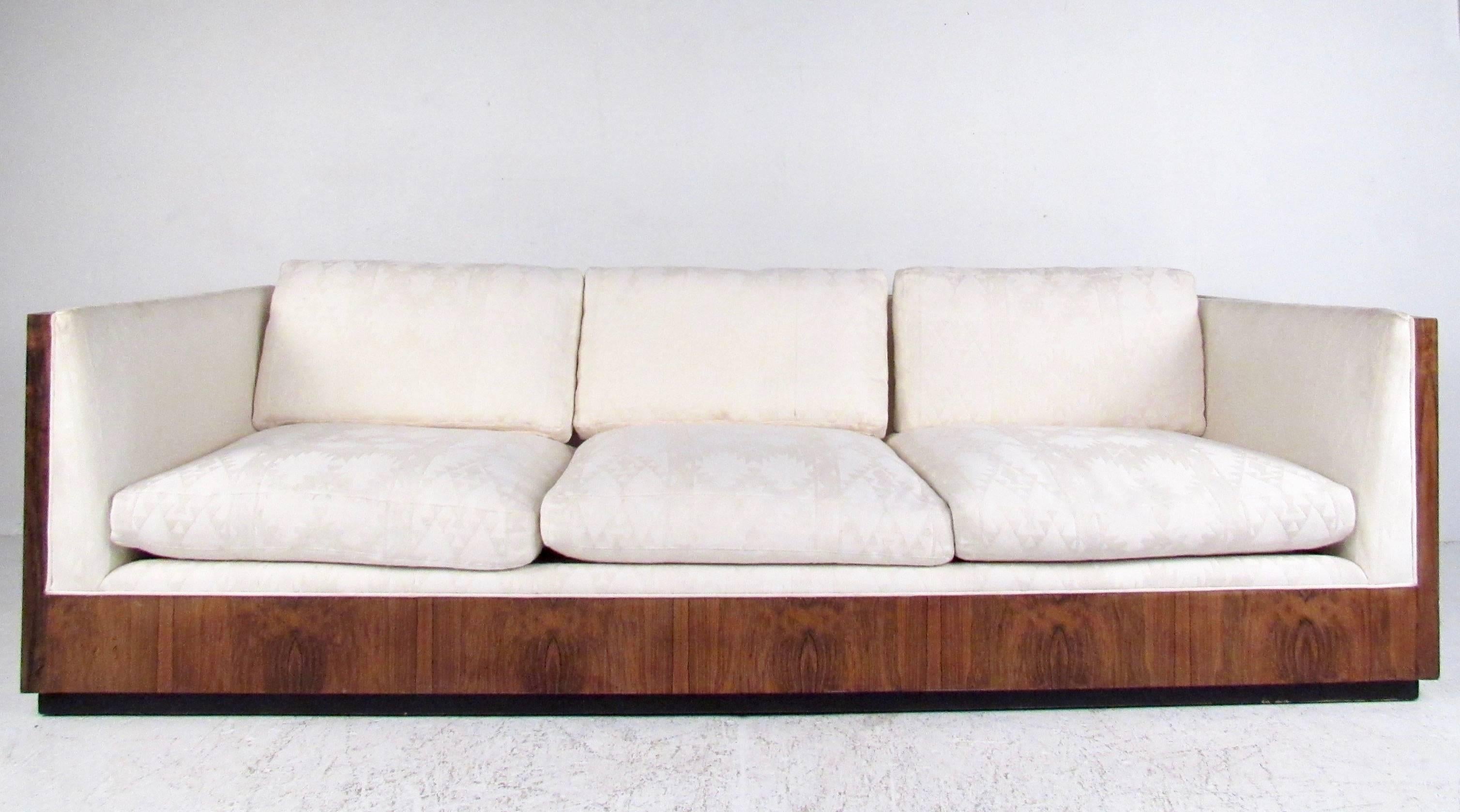 This stunning midcentury sofa features iconic Milo Baughman design for Thayer Coggin, featuring rosewood shell, wonderful vintage fabric, and comfortable seating for home or office. Original vintage condition includes manufacturing tag, please