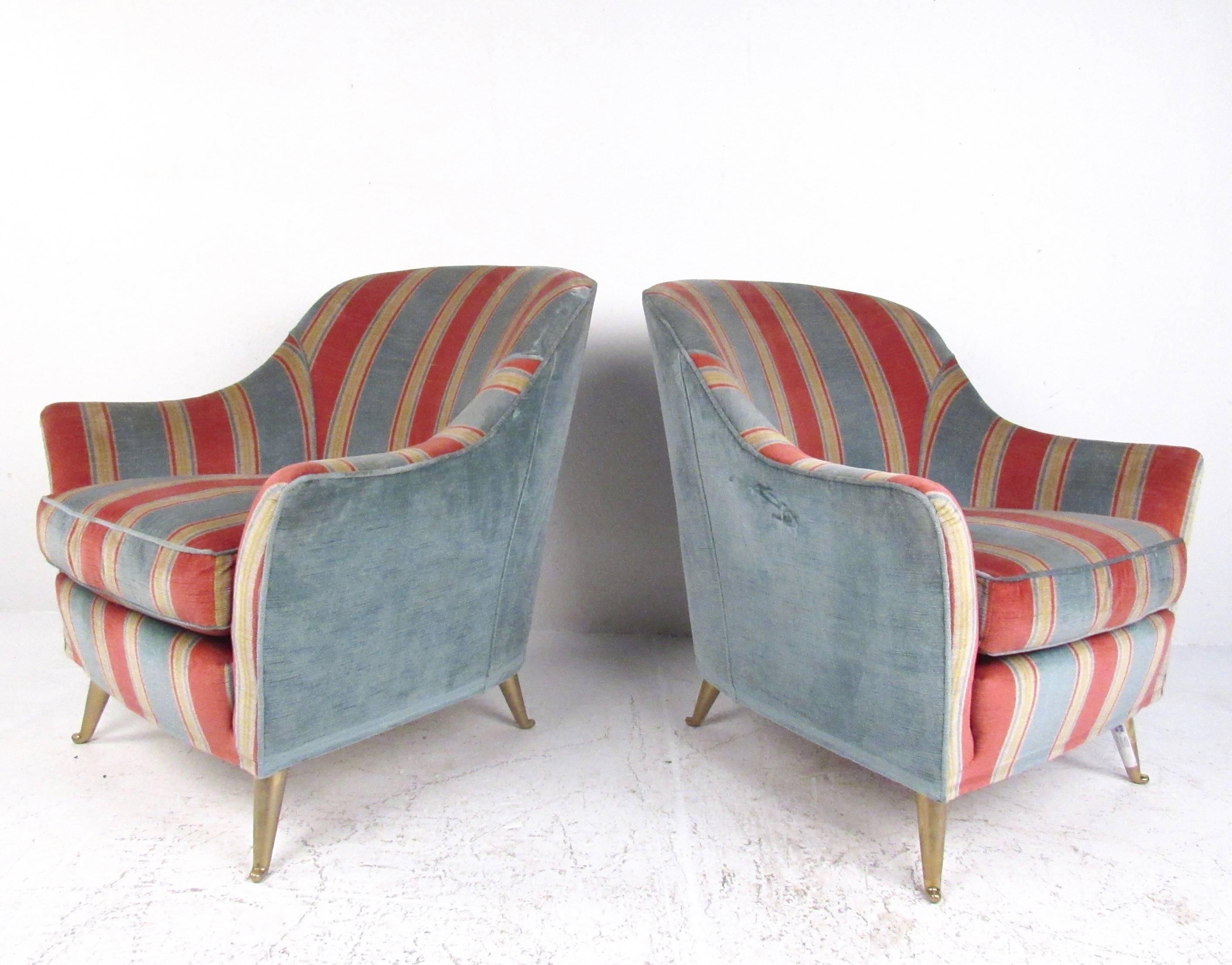 This stylish modern pair of Italian modern lounge chairs feature tapered brass legs, comfortable rounded seat backs, and unique vintage upholstery. The iconic style of Gio Ponti makes this midcentury pair the perfect addition to home or business