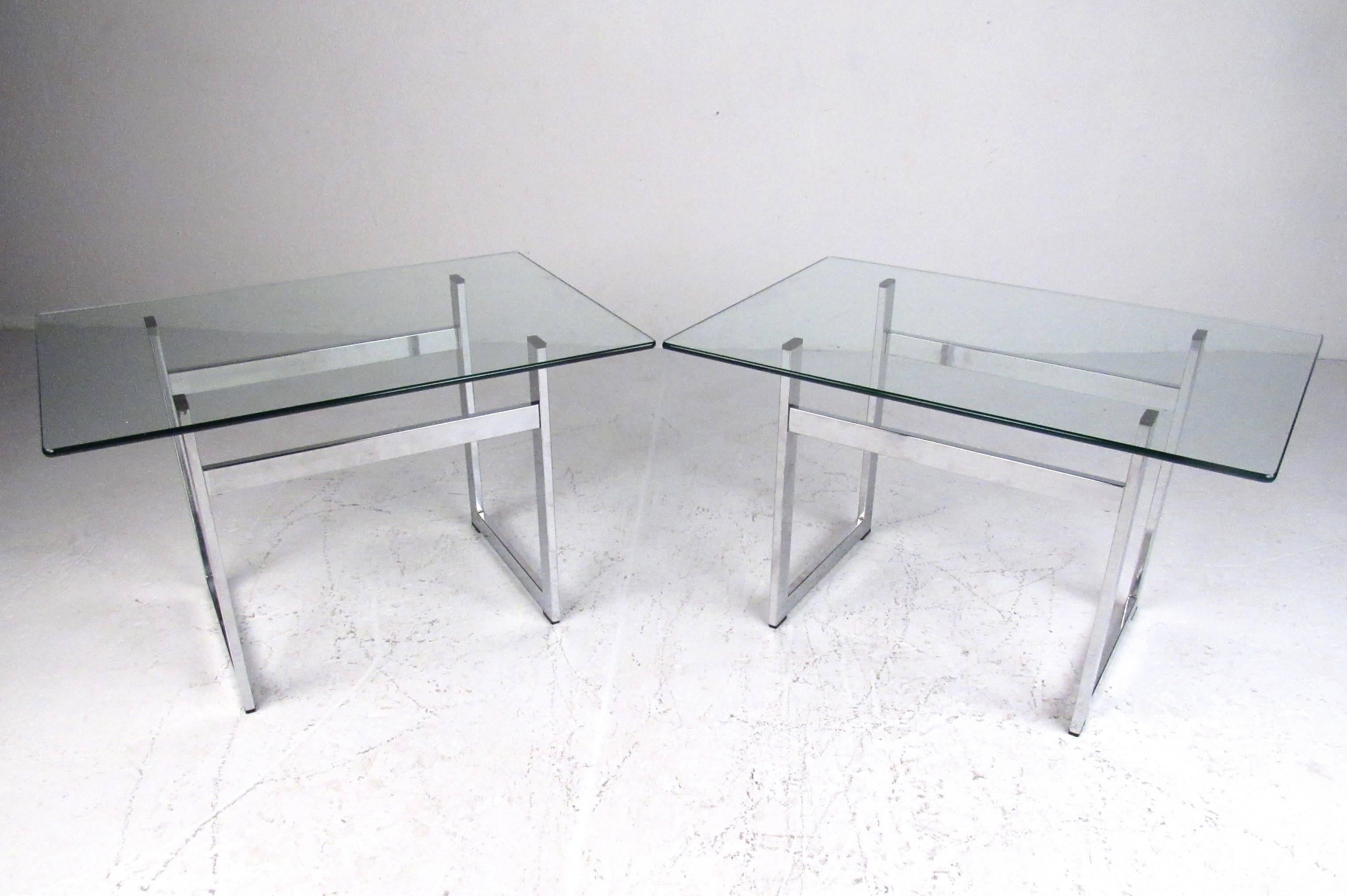 Stylish pair of contemporary modern end tables feature heavy chrome frame construction, rectangular glass tops, and unique midcentury style. Perfect addition to home or office, this matching pair make great lamp tables, sofa side tables, or display.