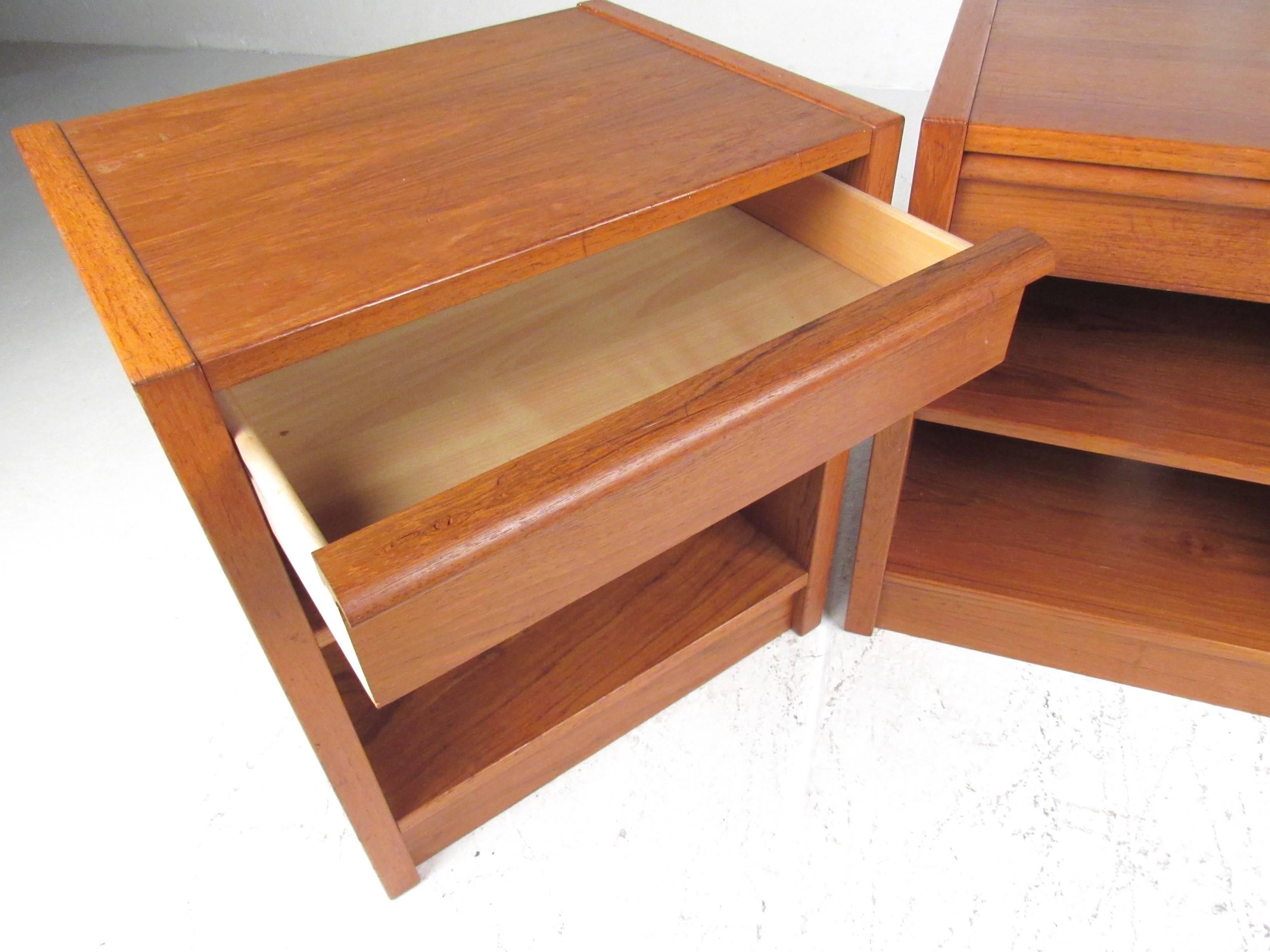 This stylish pair of Danish modern nightstands feature top drawer storage, open shelf space, and vintage teak construction. Midcentury manufacturer Jesper International. Please confirm item location (NY or NJ).