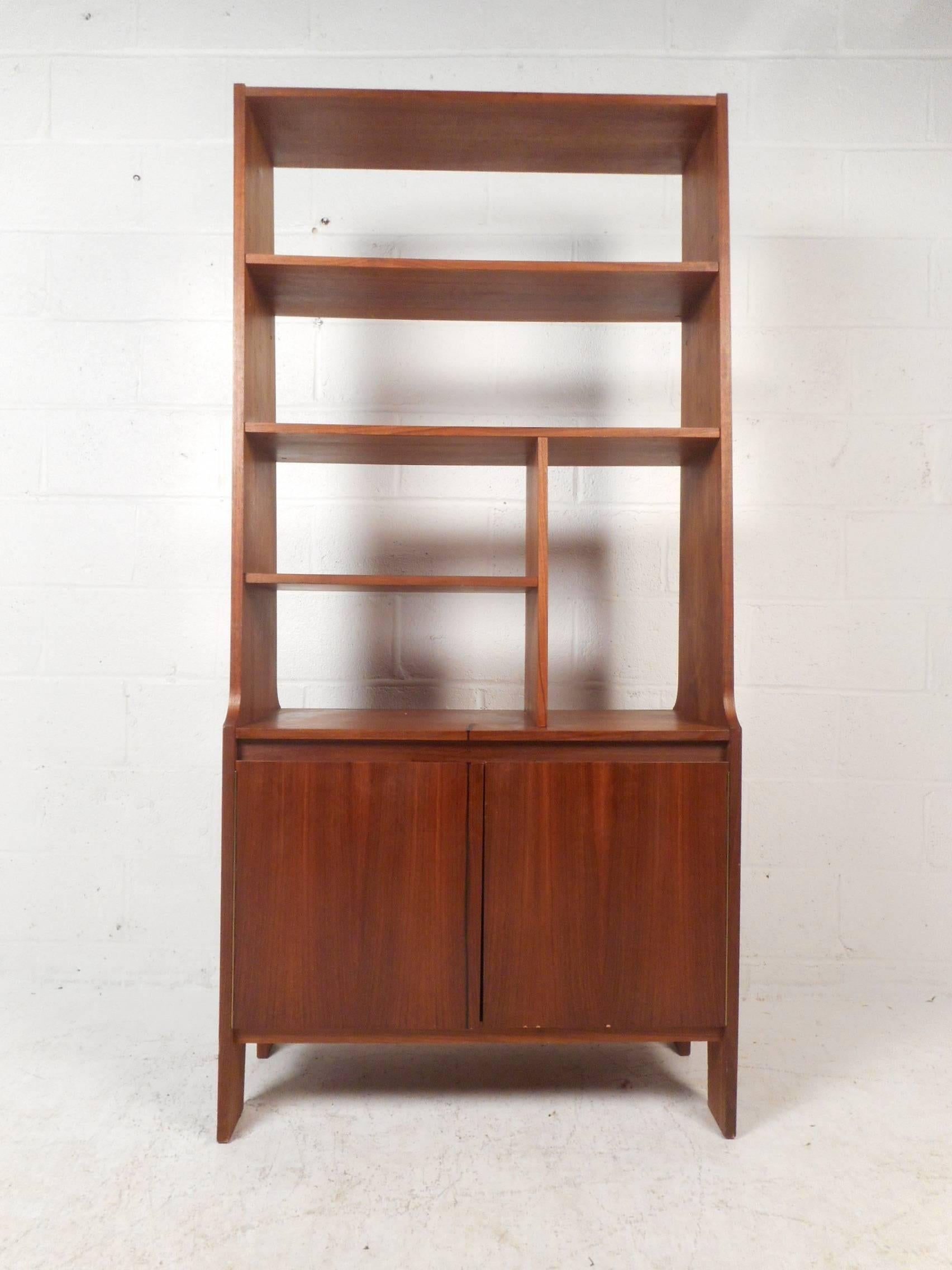 This beautiful Mid-Century Modern walnut room divider features five shelves that have various sizes and a large compartment on the bottom with a shelf for storage. Versatile design works great as an etagere, a book shelf, or a room divider. Sturdy
