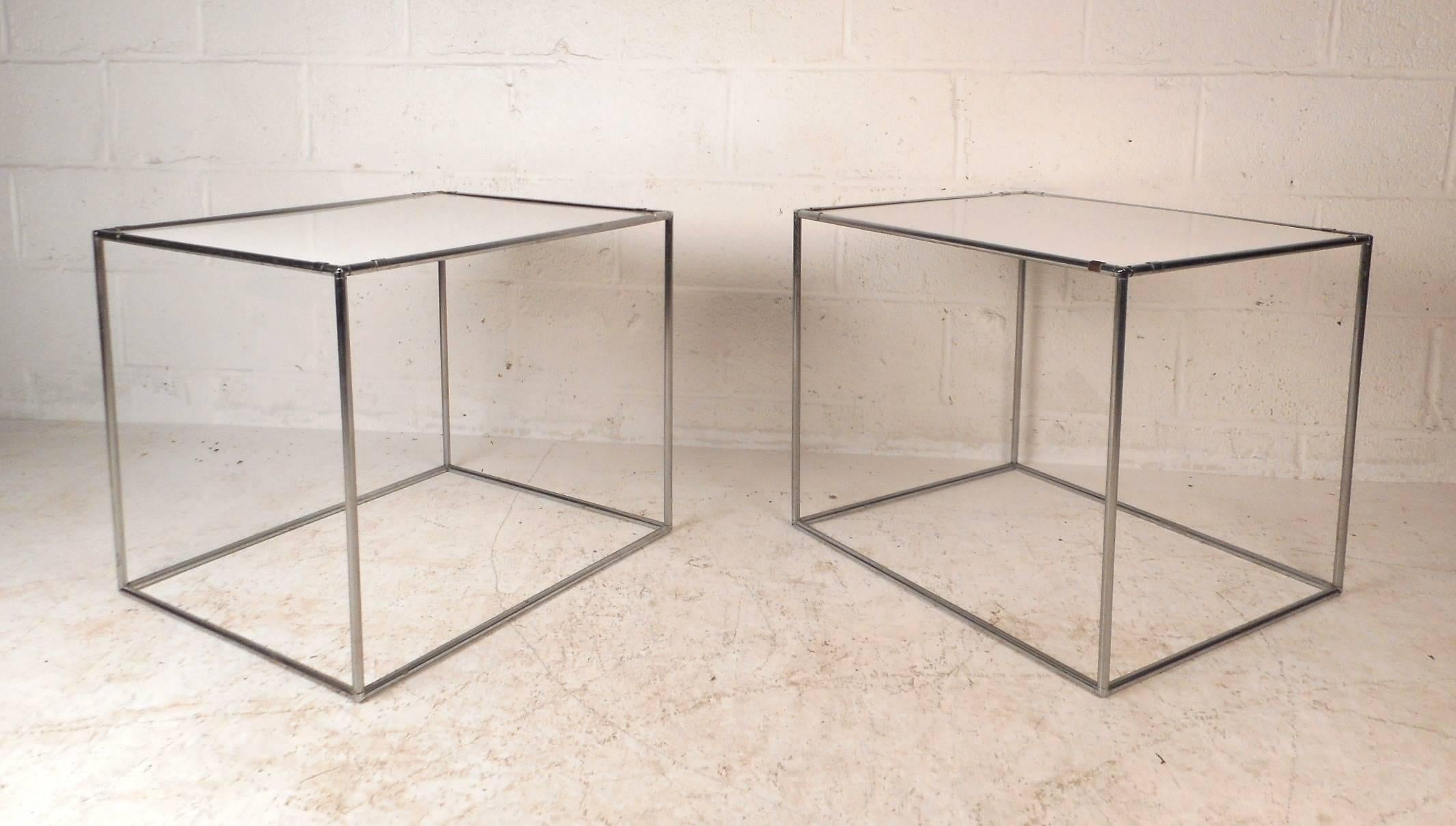 This beautiful pair of vintage modern end tables feature a unique chrome rod frame. Sleek and sturdy design with a white tabletop. This unusual midcentury pair makes the perfect addition to any modern interior. Please confirm item location (NY or