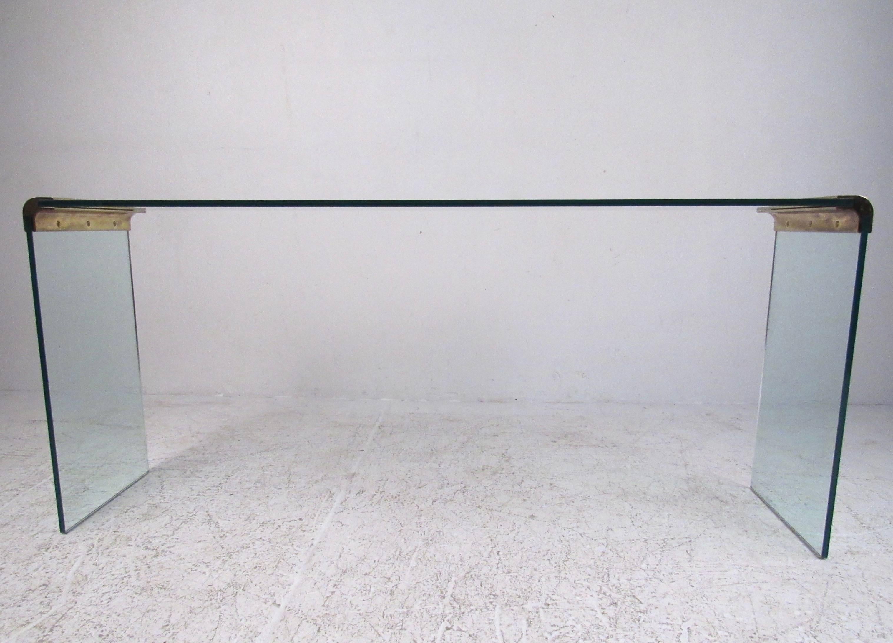 This stunning modern console table by Pace features rounded brass corners and three pieces of thick 1/2 inch glass to create the perfect sofa or entryway table. Eye catching waterfall table is perfect for accent display in home or office, please