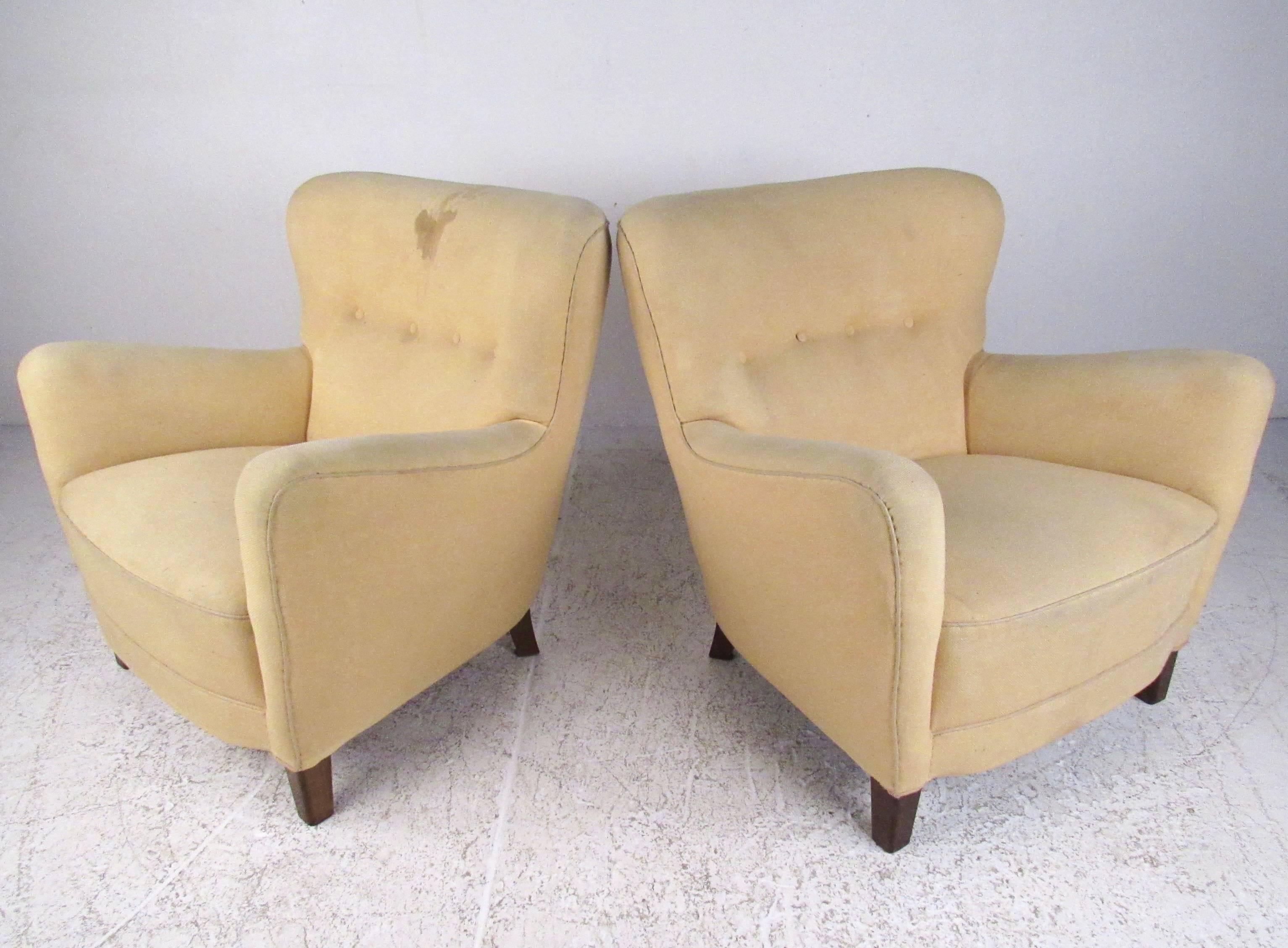 This stylish pair of shapely club chairs feature tufted upholstery make a comfortable addition to any seating area. The vintage appeal of this deco style pair makes for a warm and impressive addition to home or business seating. Please confirm item