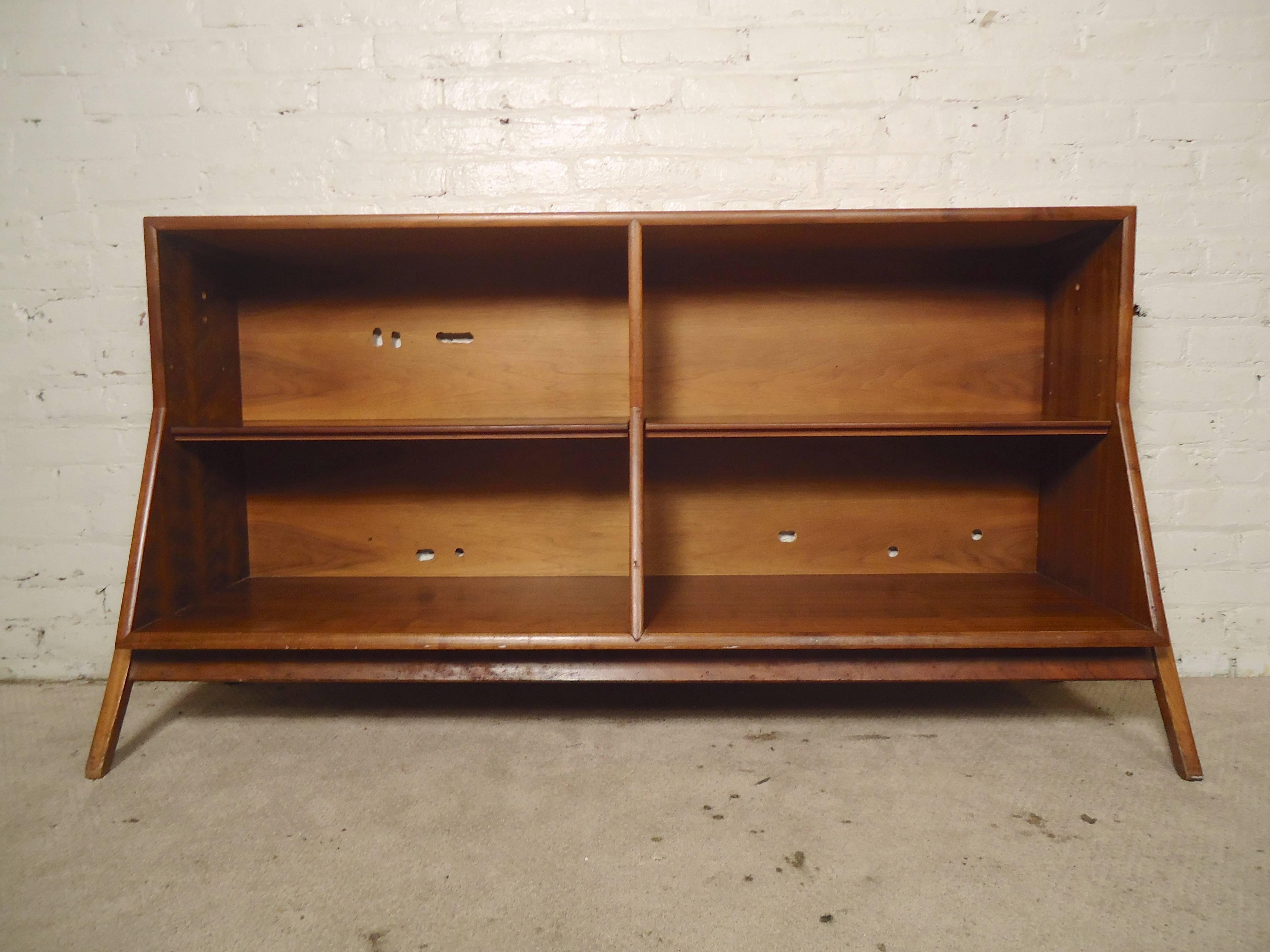 Beautiful Mid-Century open shelving unit with warm walnut grain throughout. Sculpted legs in the style of Vladimir Kagan, adjustable shelves, angled bottom cabinet.

(Please confirm item location - NY or NJ - with dealer).