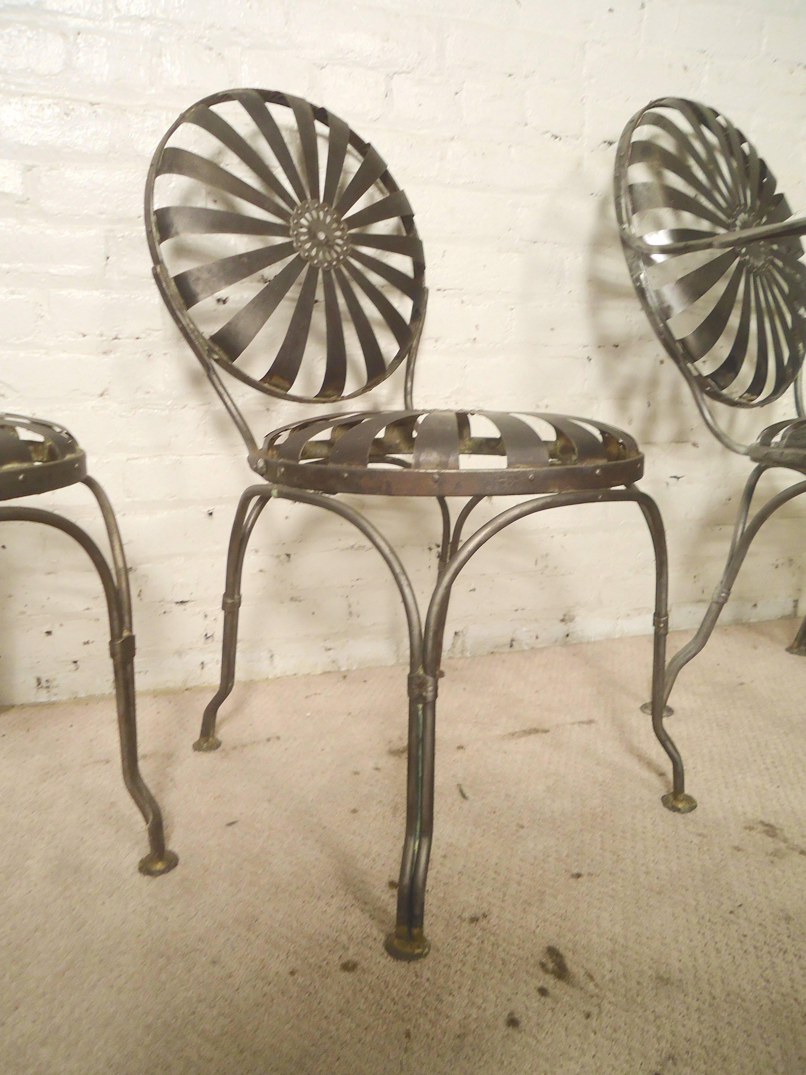 Four patio chairs by Carre restored in a bare metal finish. Spring action seat and back with strong metal legs.
Arm chairs: 23