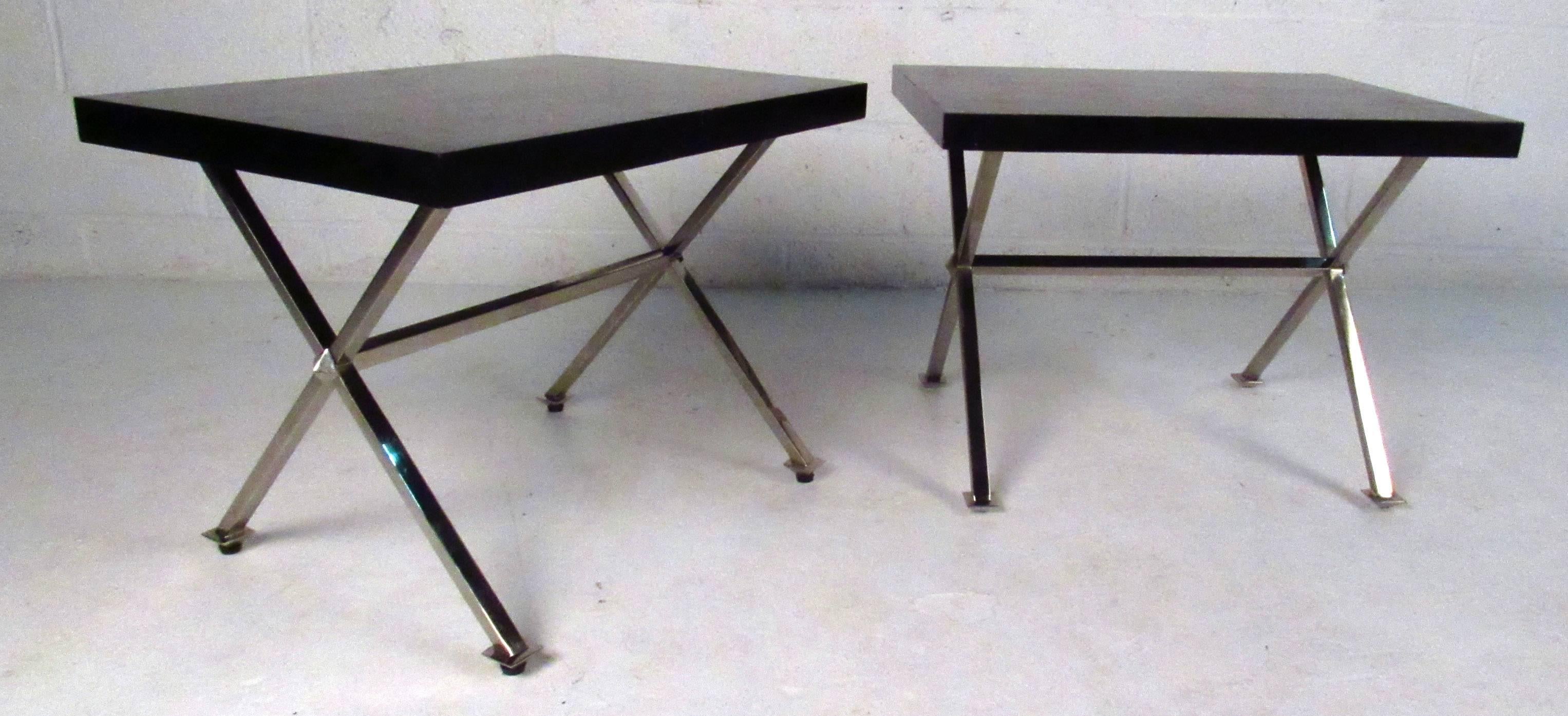 Two vintage-modern end tables each featuring a painted black top and sturdy chrome x-base. This sleek pair makes the perfect addition to any home, business, or office.

Please confirm item location NY or NJ with dealer.