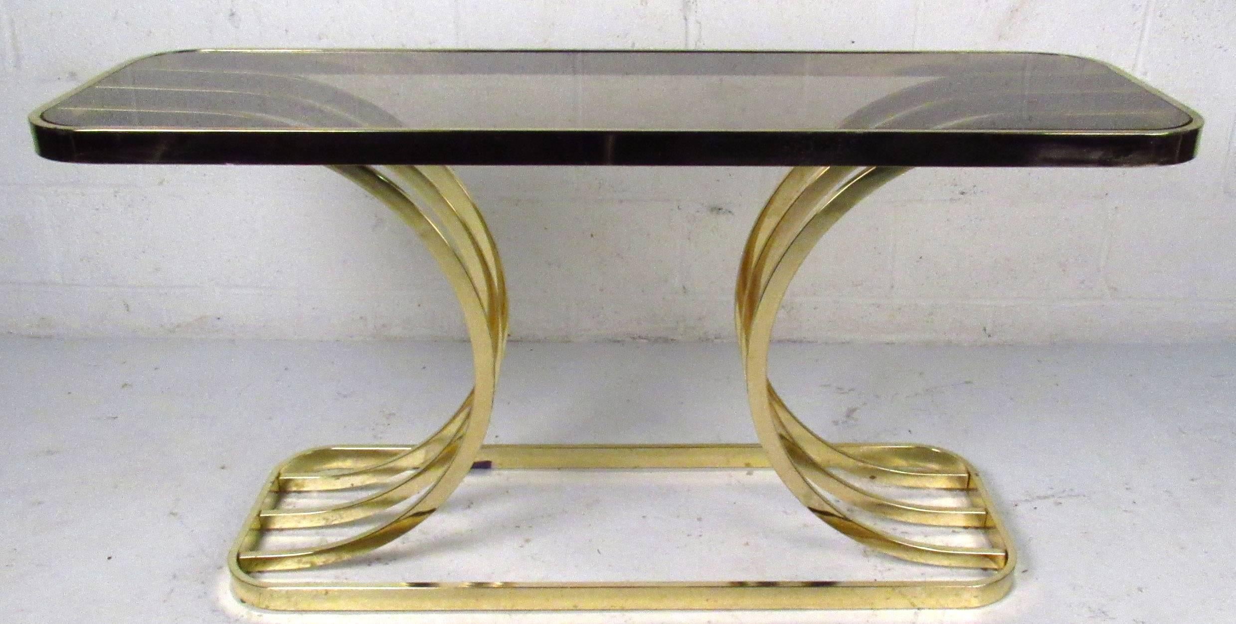 A contemporary modern glass top console table featuring a sculpted brass finish base, a unique table for entryway, hall, or sofa. 

Please confirm item location NY or NJ with dealer.