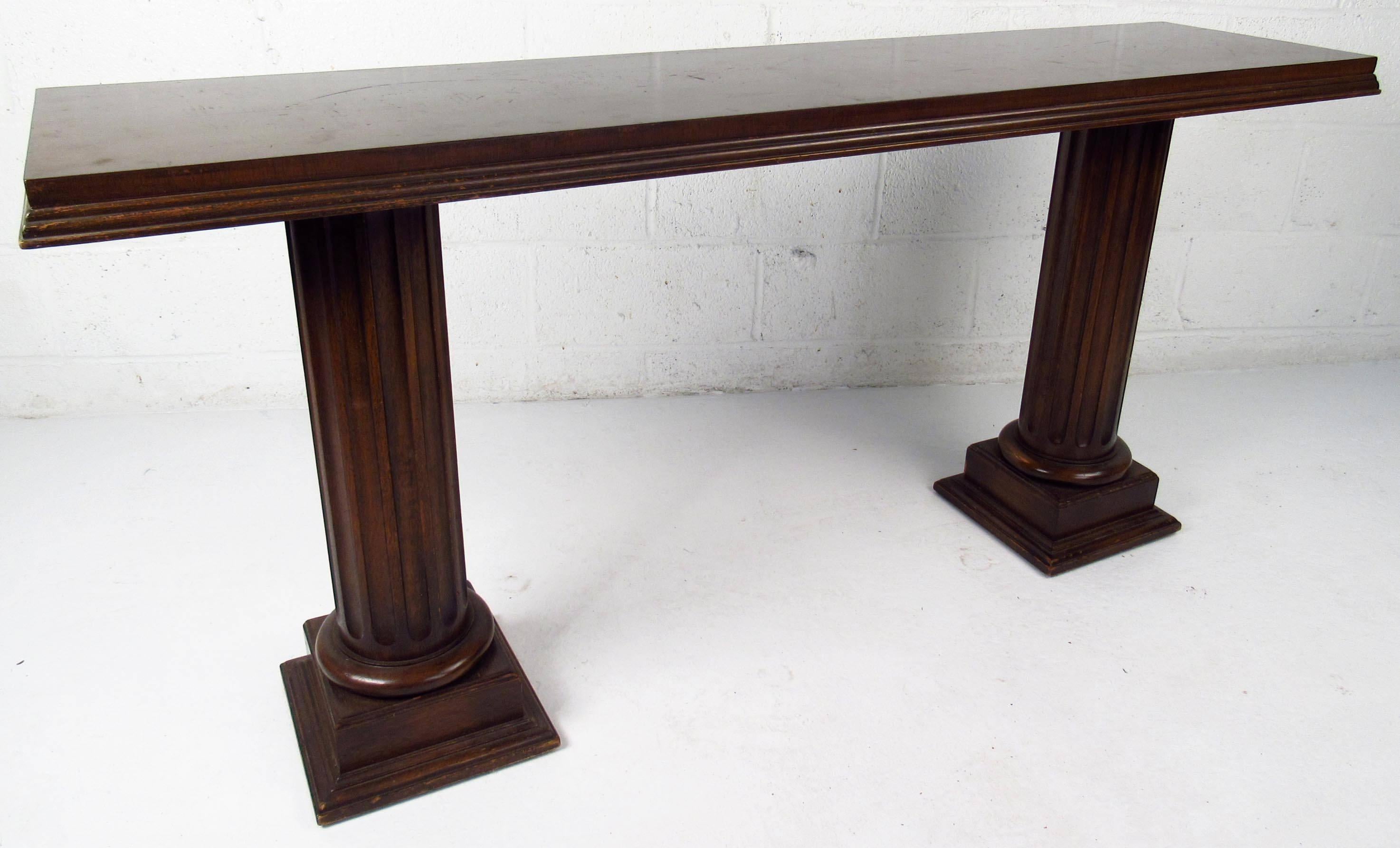 Vintage-modern sofa console table, features sculpted double column base and solid top with carved trim.

Please confirm item location NY or NJ with dealer.