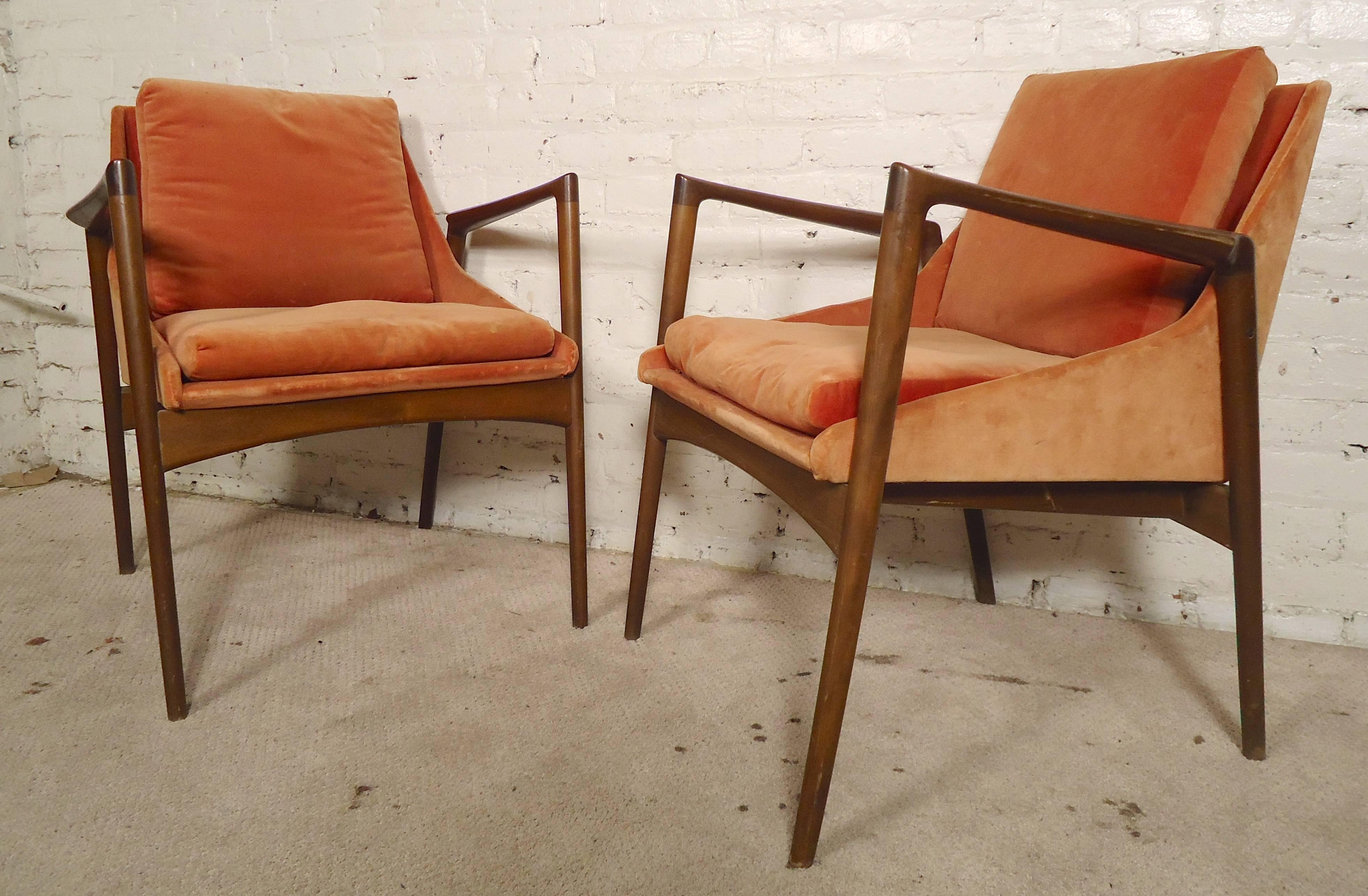 Beautiful mid-century modern arm chairs designed by Kofod-Larsen for Selig. Great sculpted arms and wood frames with bucket style seats.

(Please confirm item location - NY or NJ - with dealer)