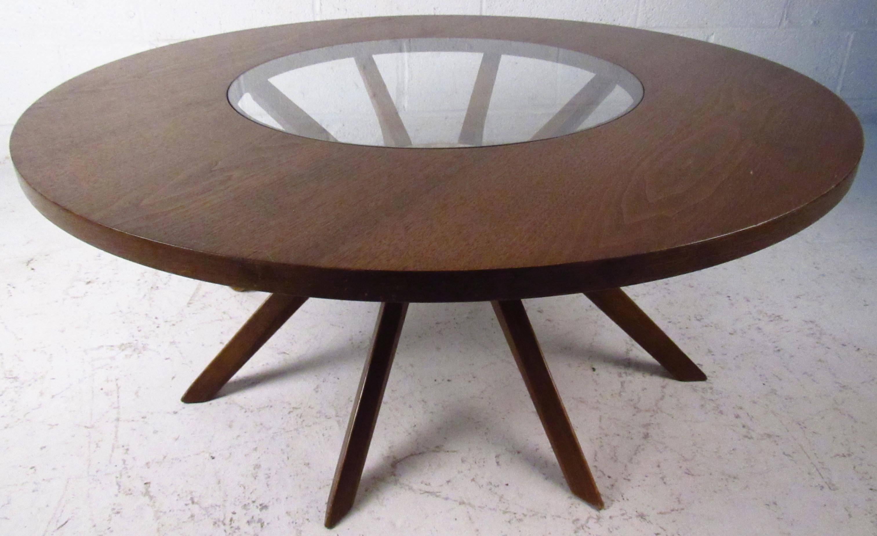Beautiful vintage coffee table features sculpted legs, round top with glass center, manufactured by Broyhill. 
Please confirm item location NY or NJ with dealer.