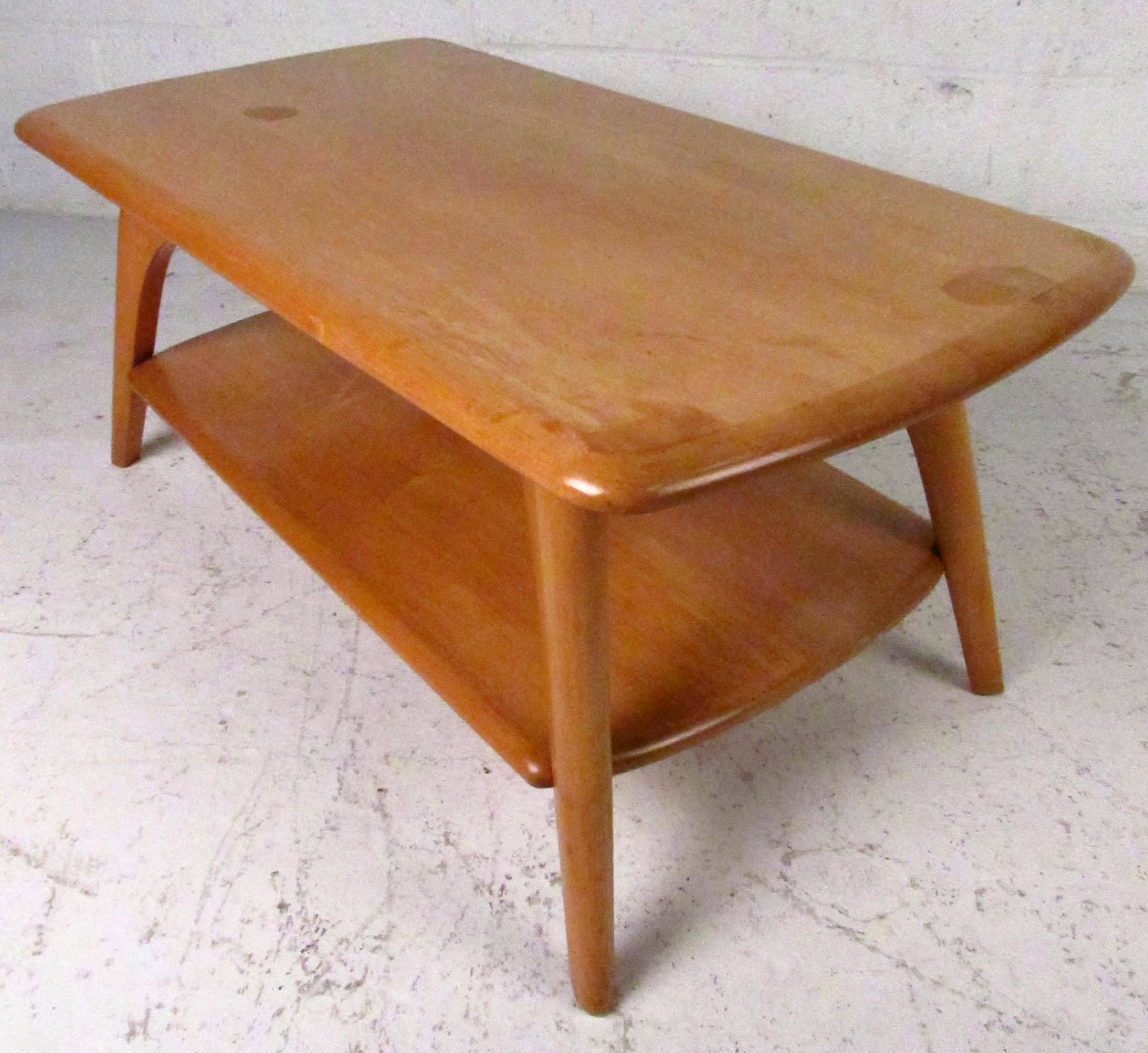 Vintage-modern two-tier maple coffee table featuring sturdy sculpted legs, designed by Brewster-Beauchemin.

Please confirm item location NY or NJ with dealer.